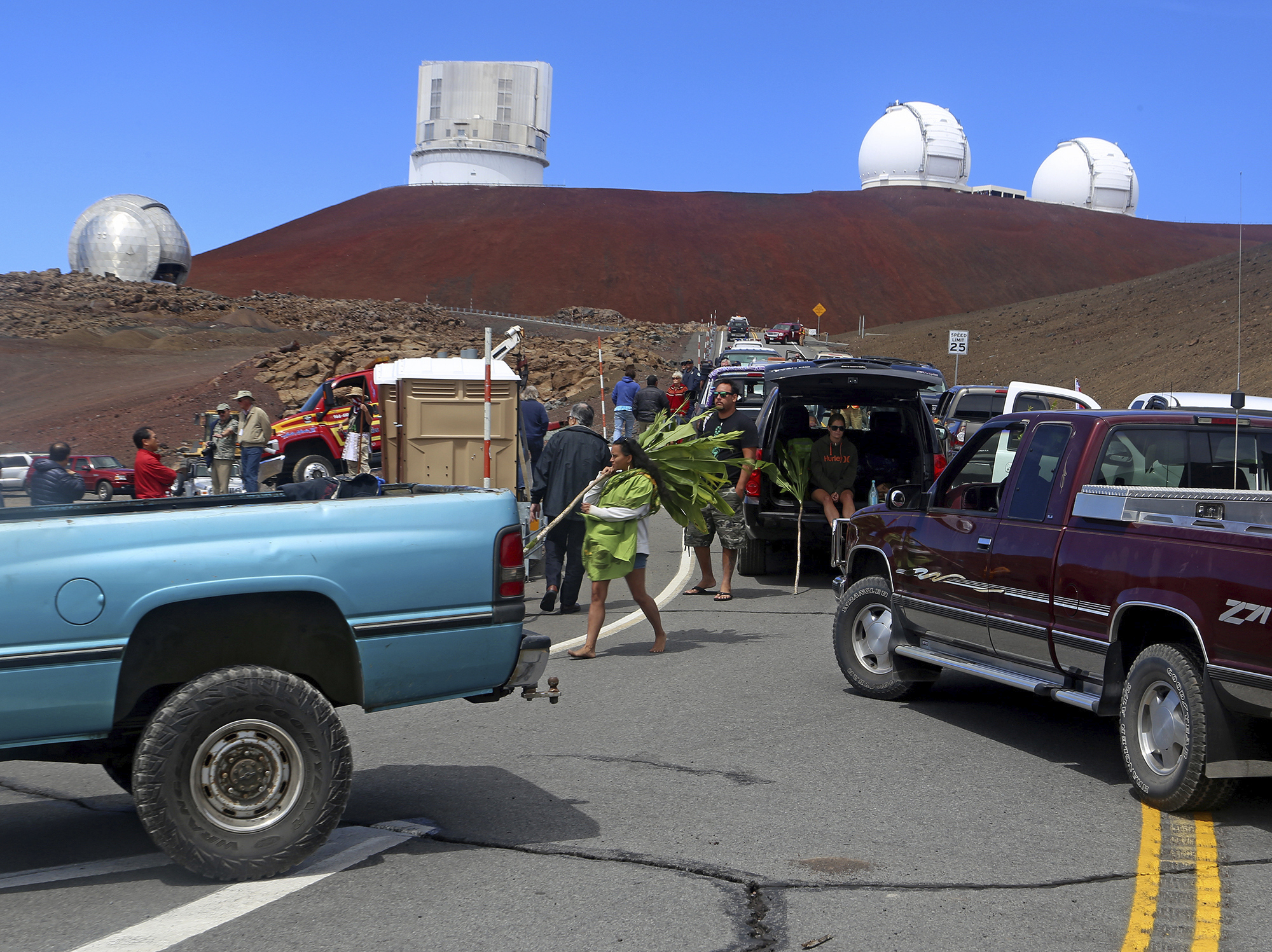 Protesters block vehicles from getting to the Thirty Meter Telescope groundbreaking ceremony site at Mauna Kea, Hawaii, in 2014