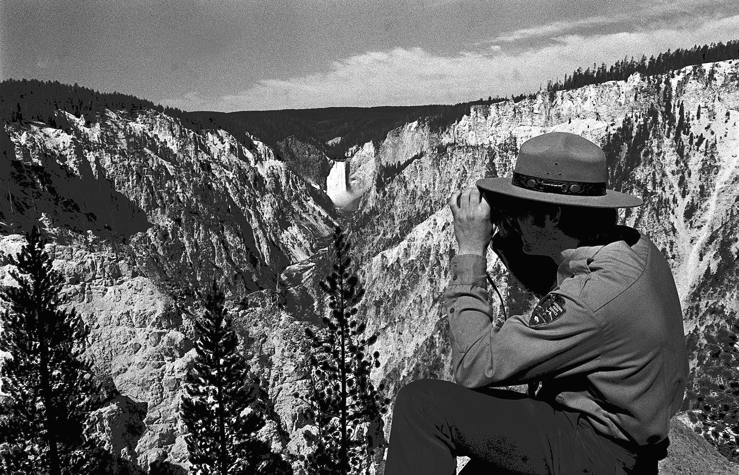 A ranger looks at the Grand Canyon