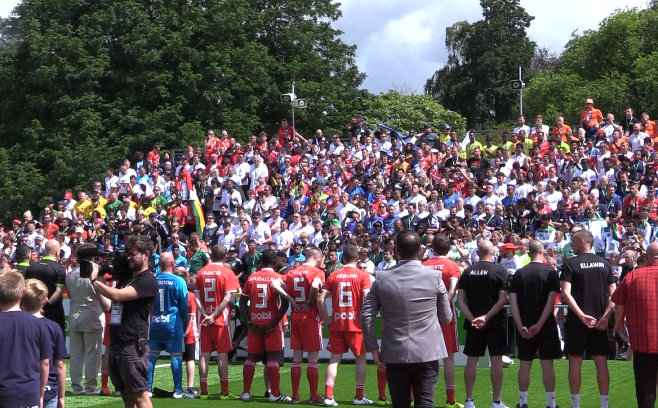 Wales and Denmark line up for the national anthems ahead of the opening men's game at the Homeless World Cup