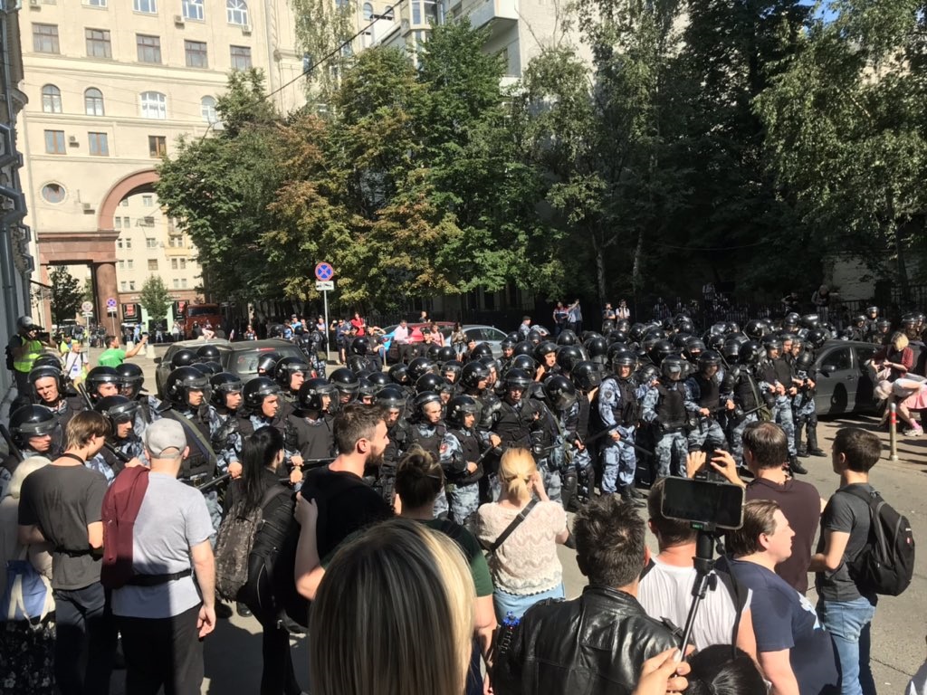 Riot police confronting protesters in Moscow
