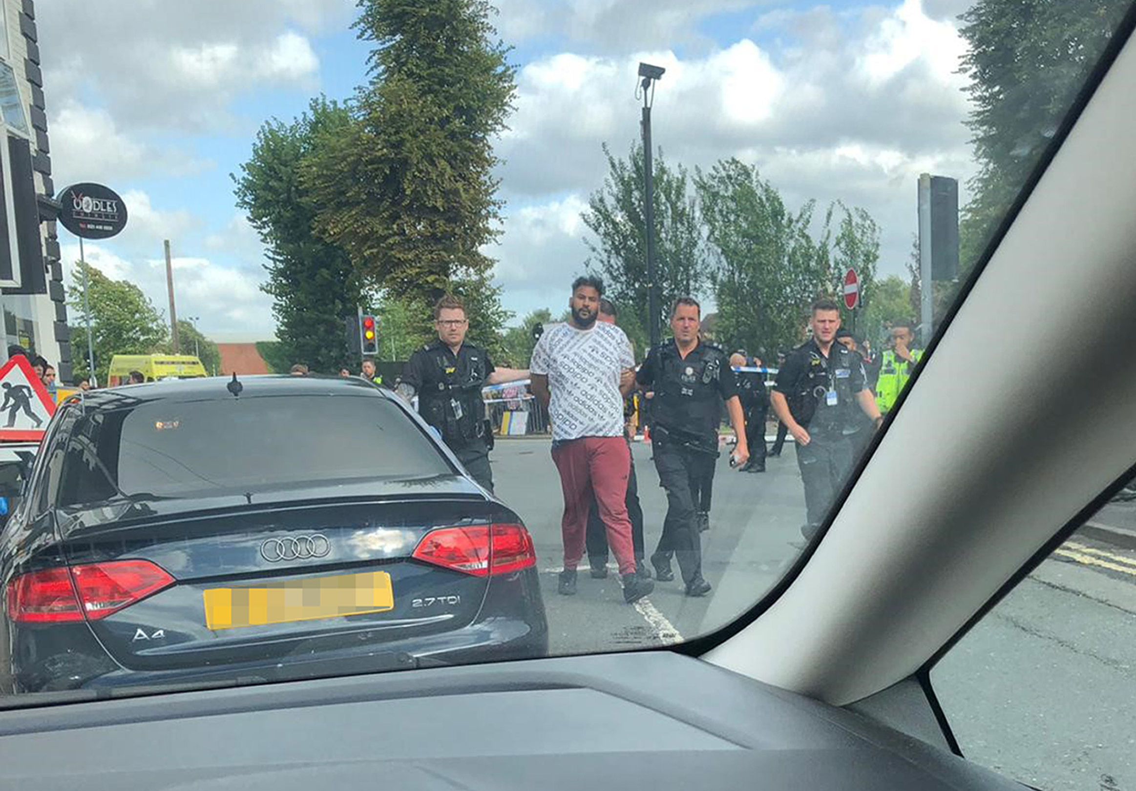 A man being detained by police after an incident in Moorcroft Road, Moseley, Birmingham, where a police officer has been seriously injured after being run over by a suspected car thief. (Sohail Razaque/PA)