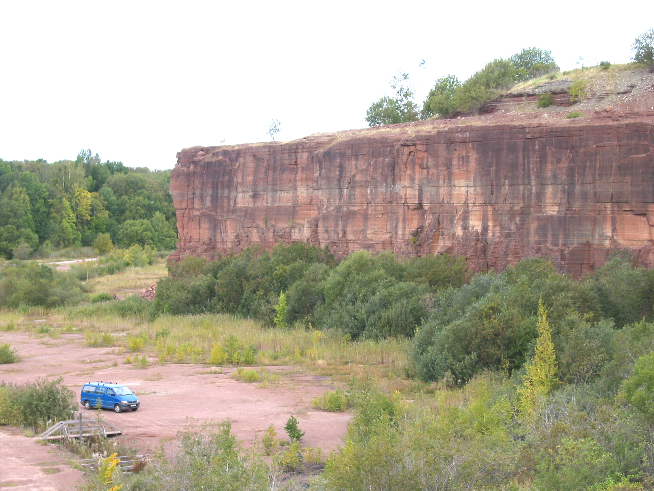 Cliffs made of sedimentary rock that was once an ancient seabed. The gray horizontal line in the rock shows where the dust from the asteroid collision fell.