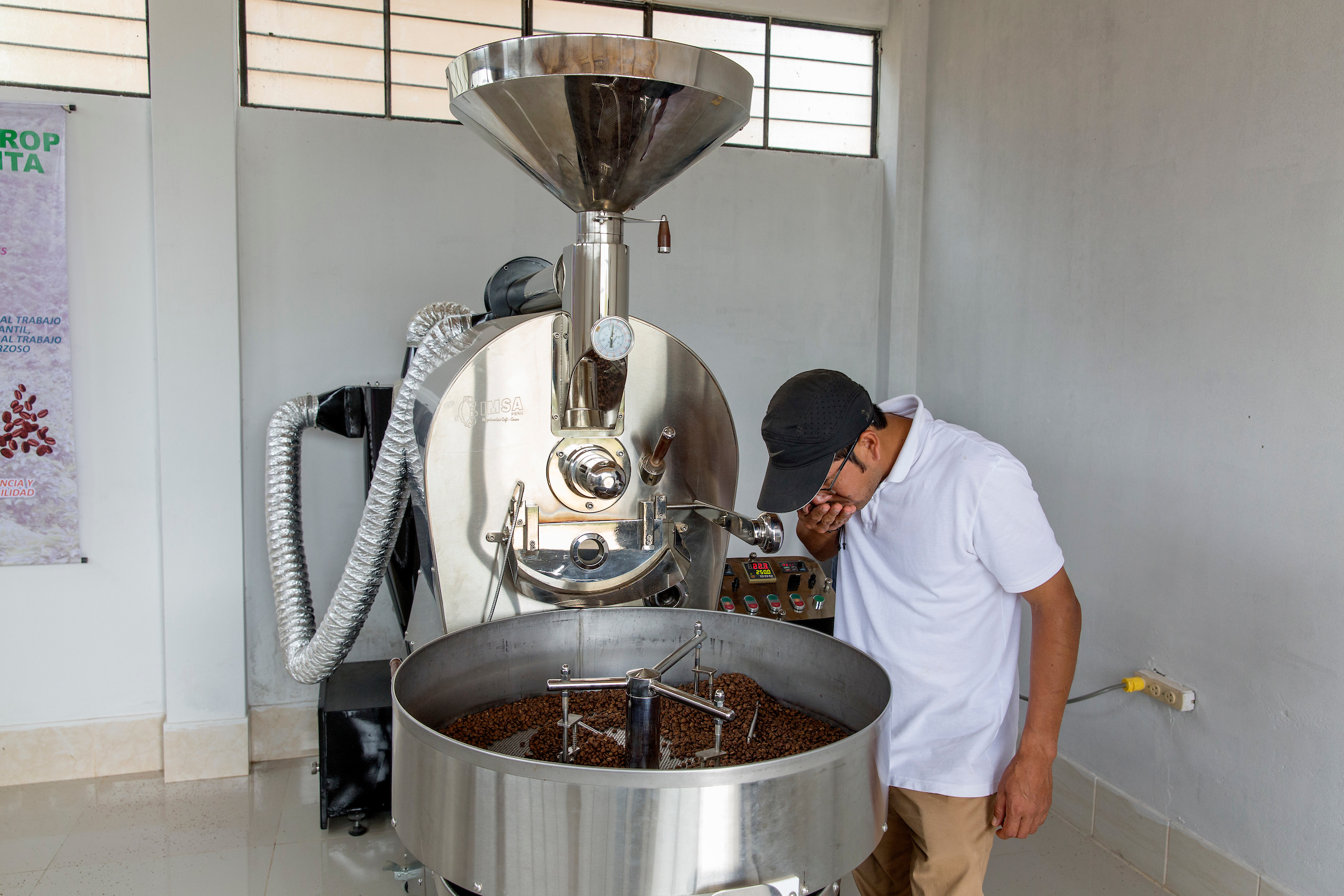  Hugo Javier Guerrero smells freshly-roasted beans at the family farm in Piura 