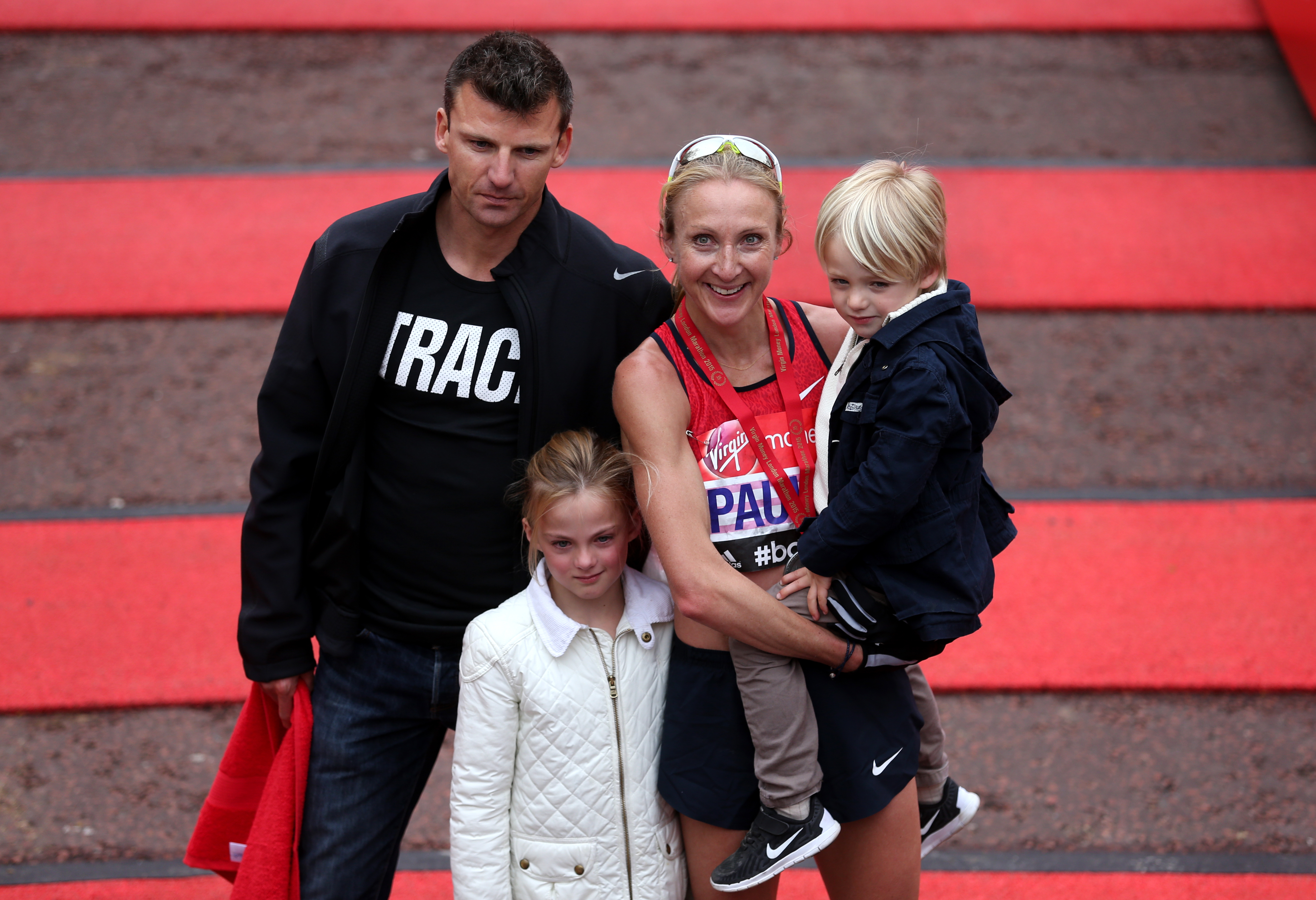 Paula Radcliffe celebrates completing the 2015 Virgin Money London Marathon with her family.
