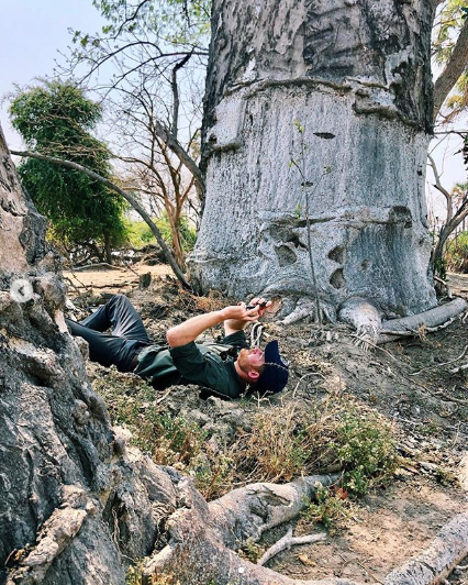 Harry taking his picture under the tree