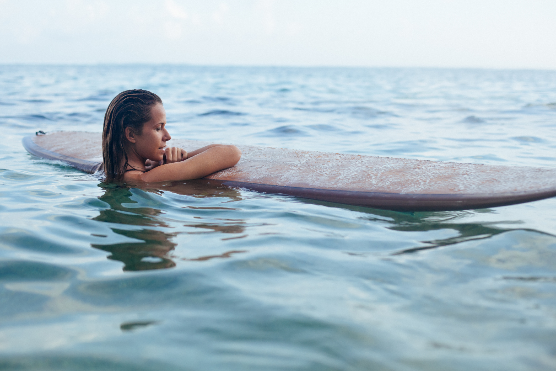 Surfer girl on surfboard have a fun before surfing