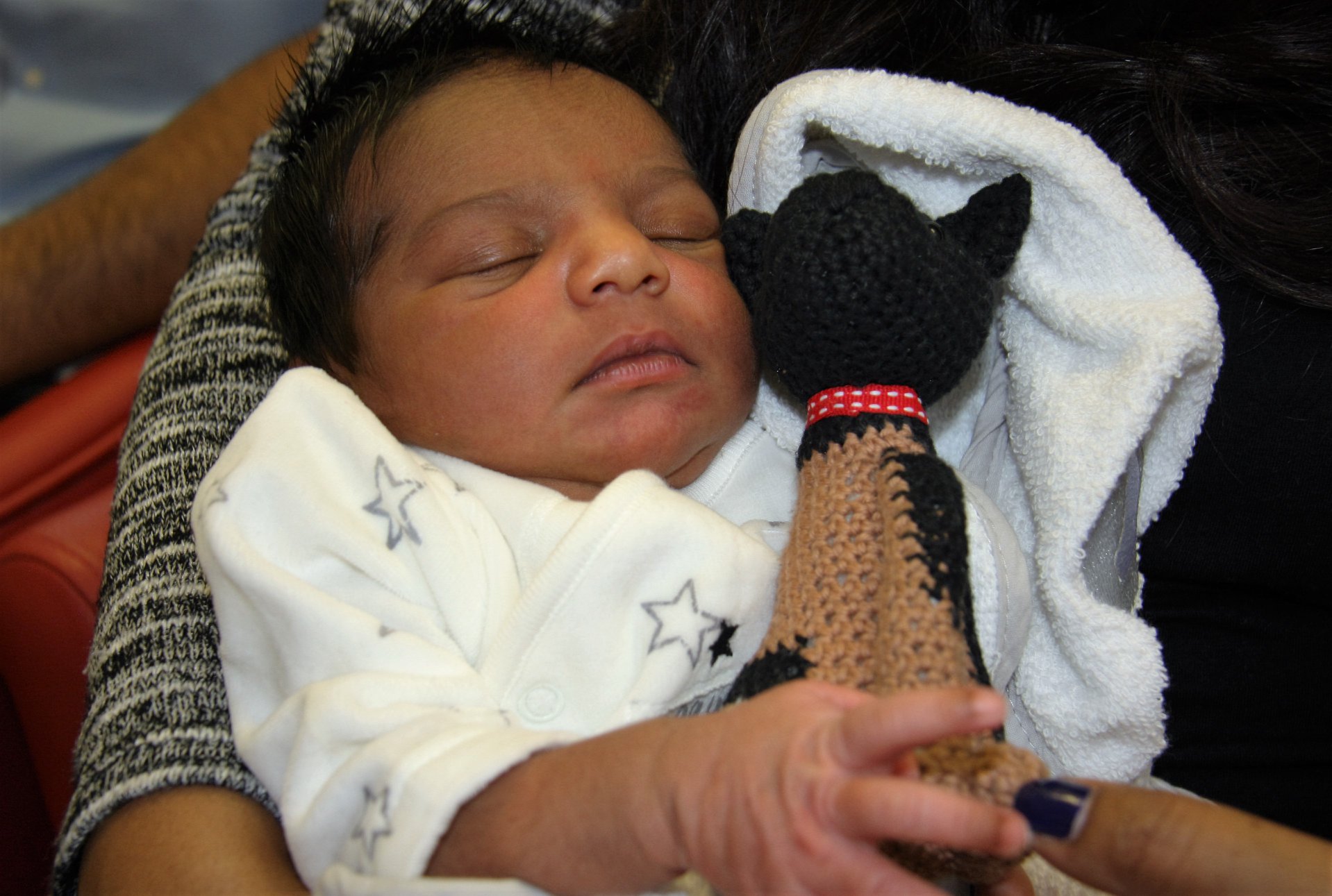 Baby Abiman with their new cuddly toy, Police Dog Baloo