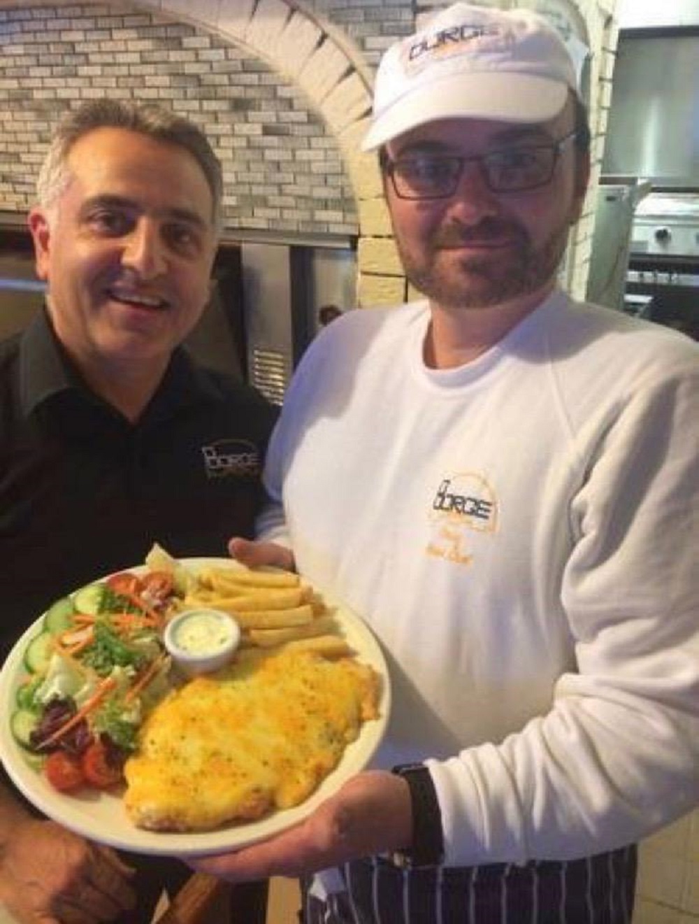 Mr Khalili with one of his staff members and the winning parmo