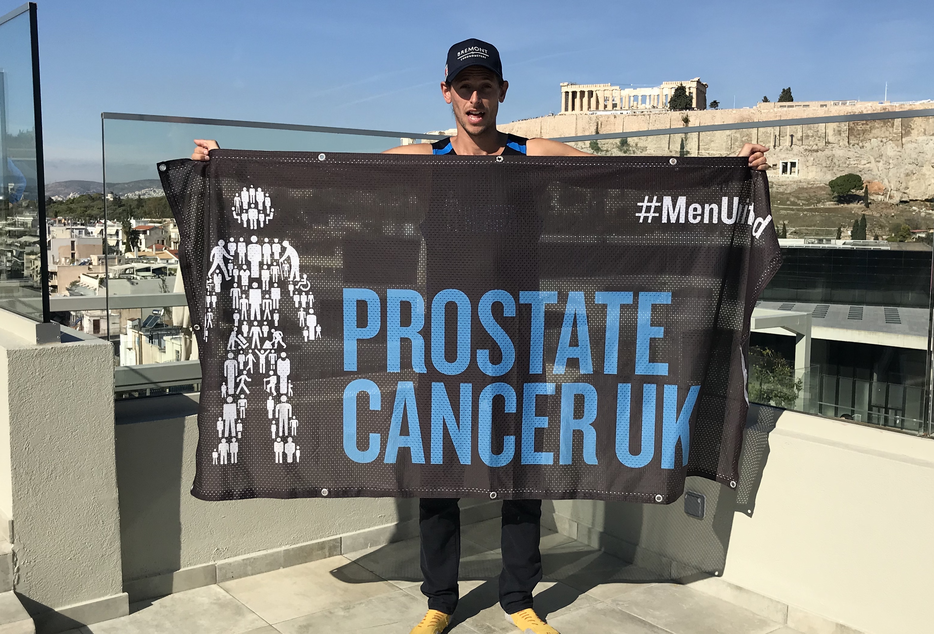 Ultra runner Nick Butter with a Prostate Cancer UK banner