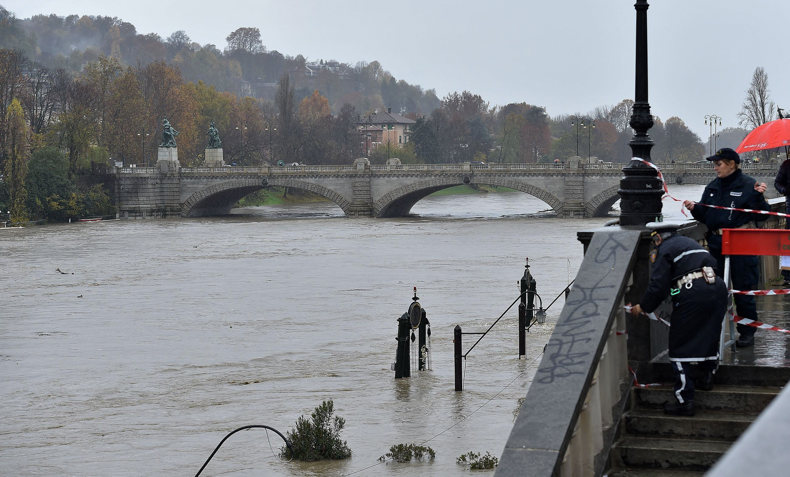 Police seal off a stairway leading to the river banks as the water levels of the river Po rise, in the Murazzi area of Turin
