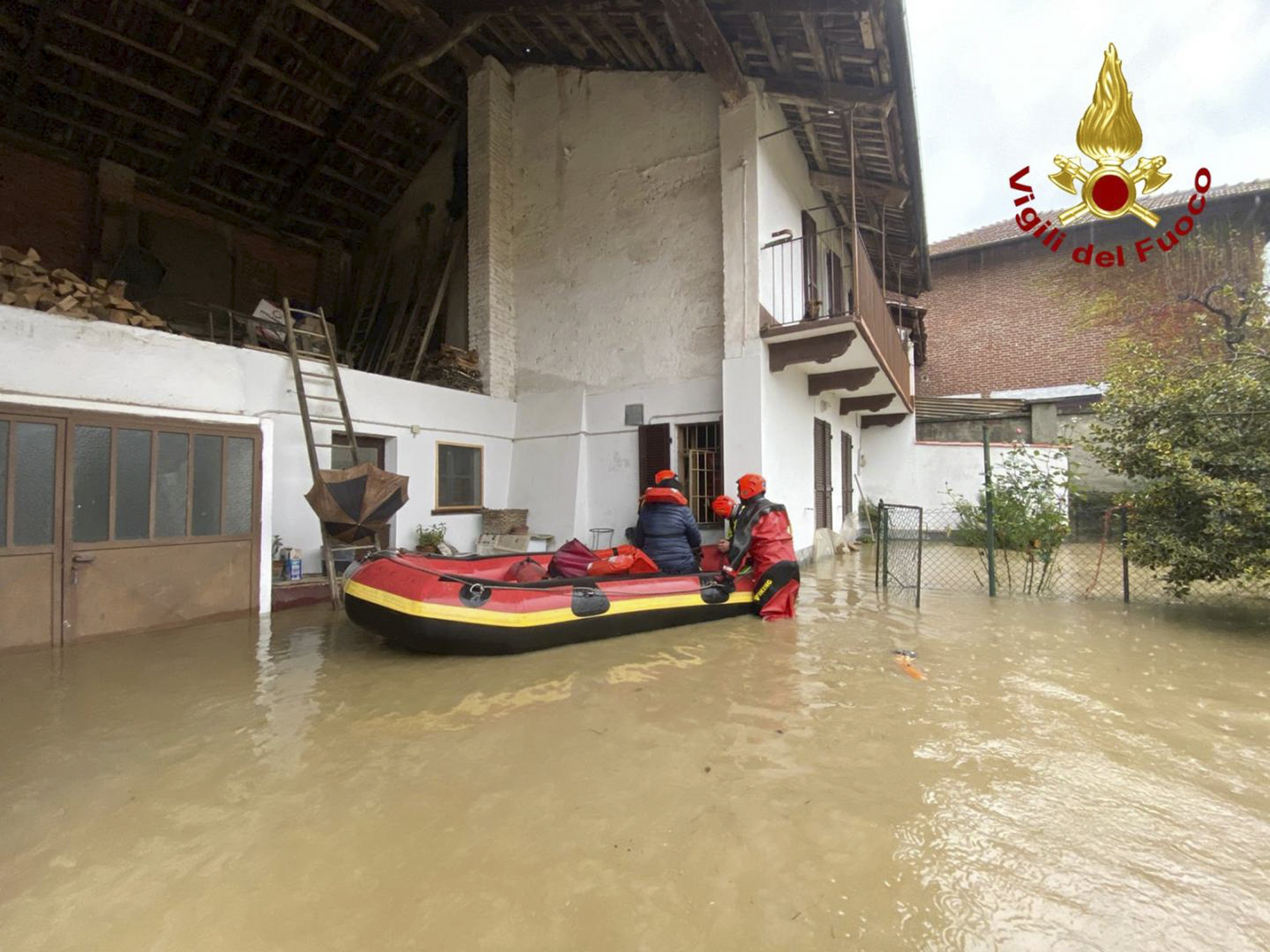 Firefighters evacuate people from house in Carde, near Cuneo, in the Piedmont region of northern Italy 