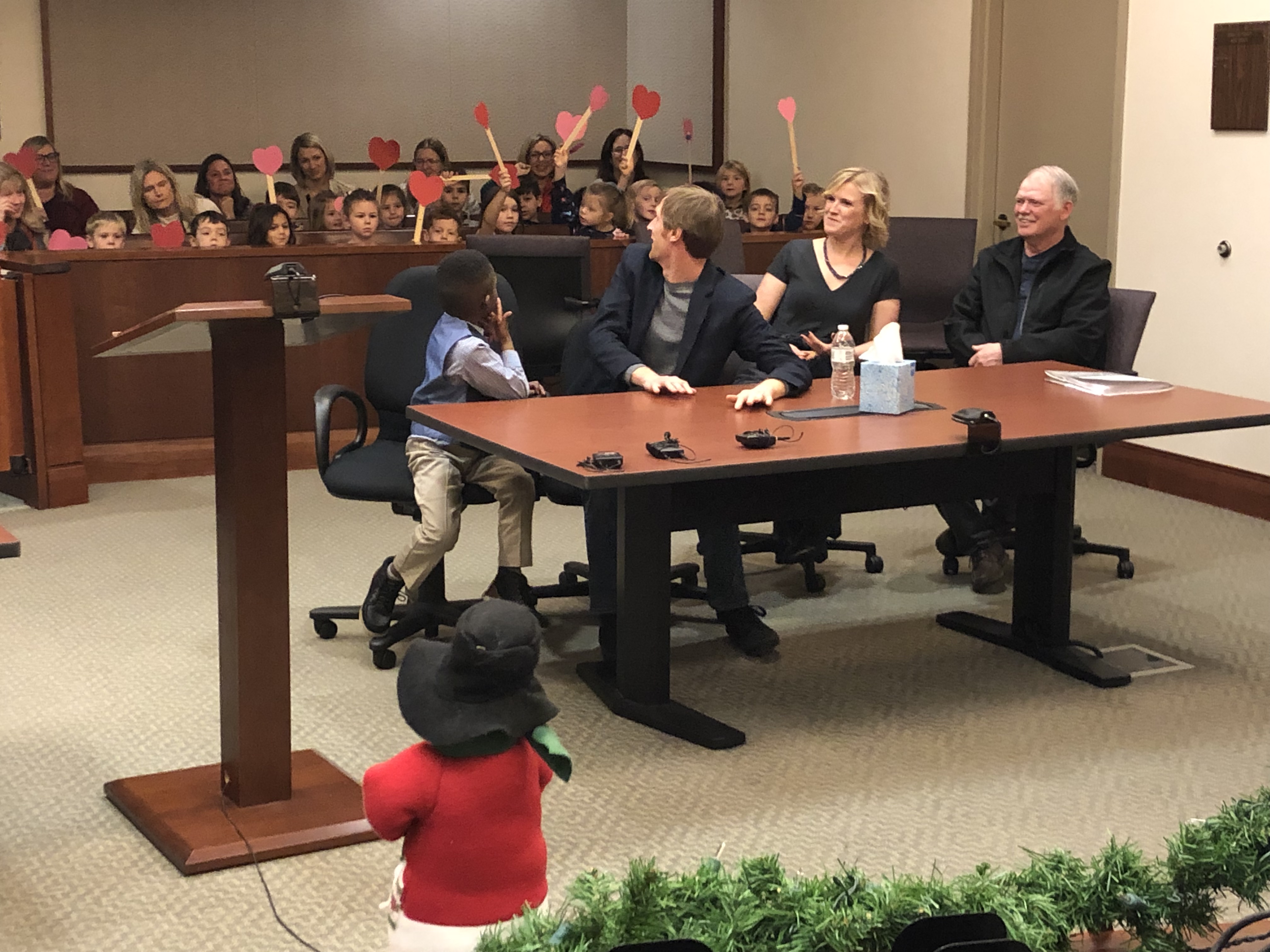 Michael with his class behind him at an adoption hearing