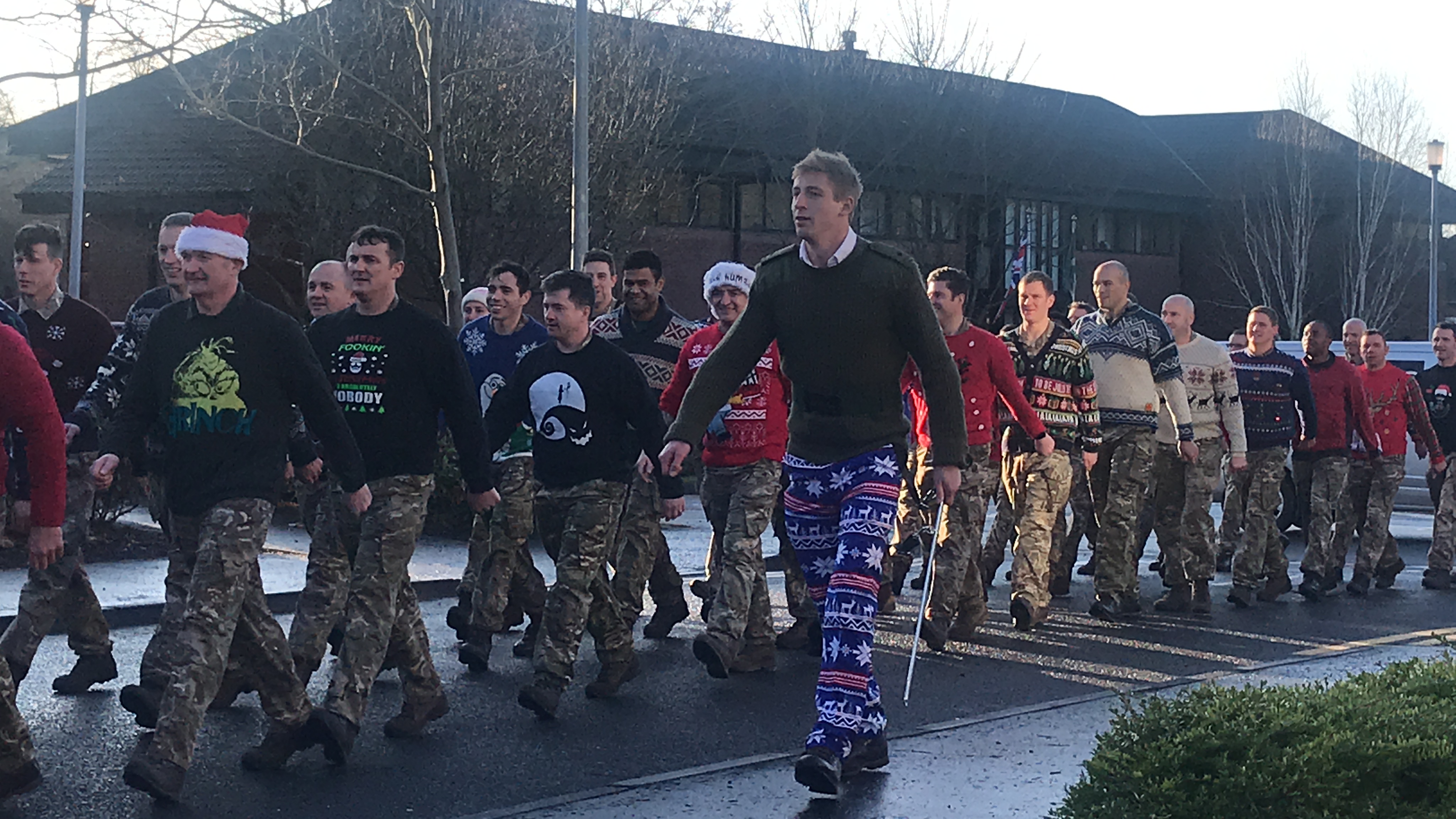 The officers of 2 Rifles are marched across Thiepval Barracks to serve Christmas lunch to the lower ranks