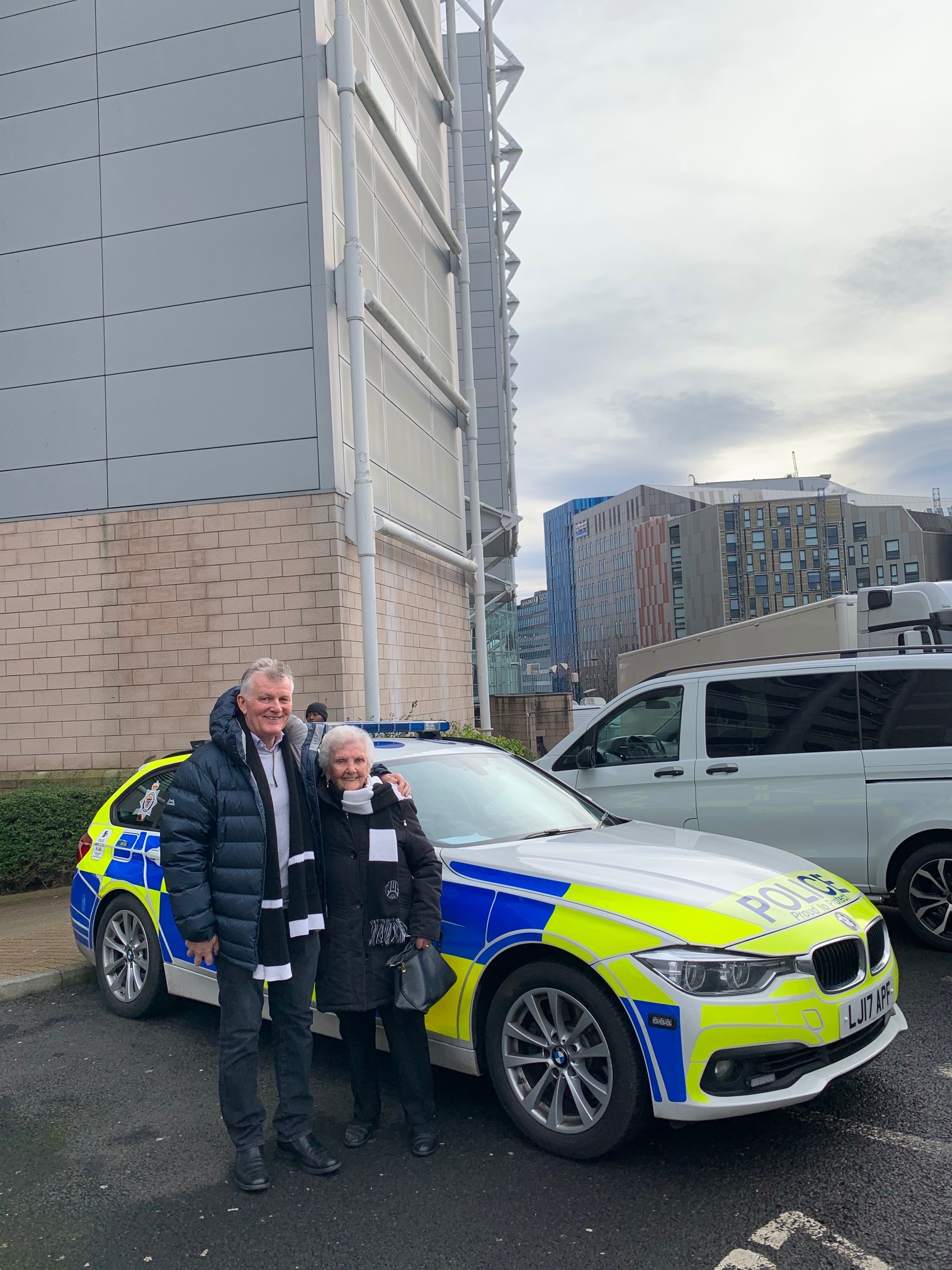 Florence Rudd, a lifelong Newcastle fan, stands next to a police car