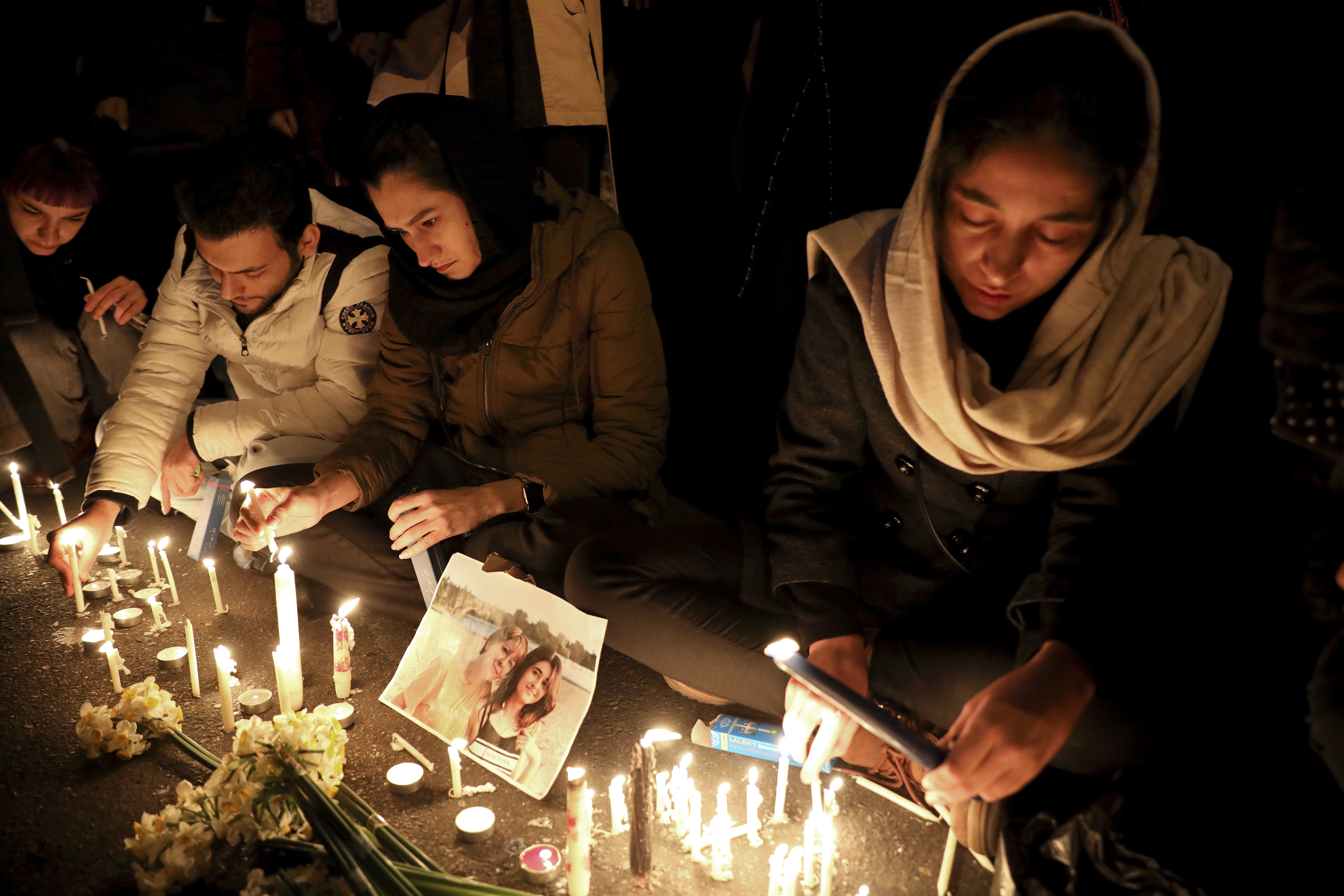 People gather for a candlelight vigil in Tehran