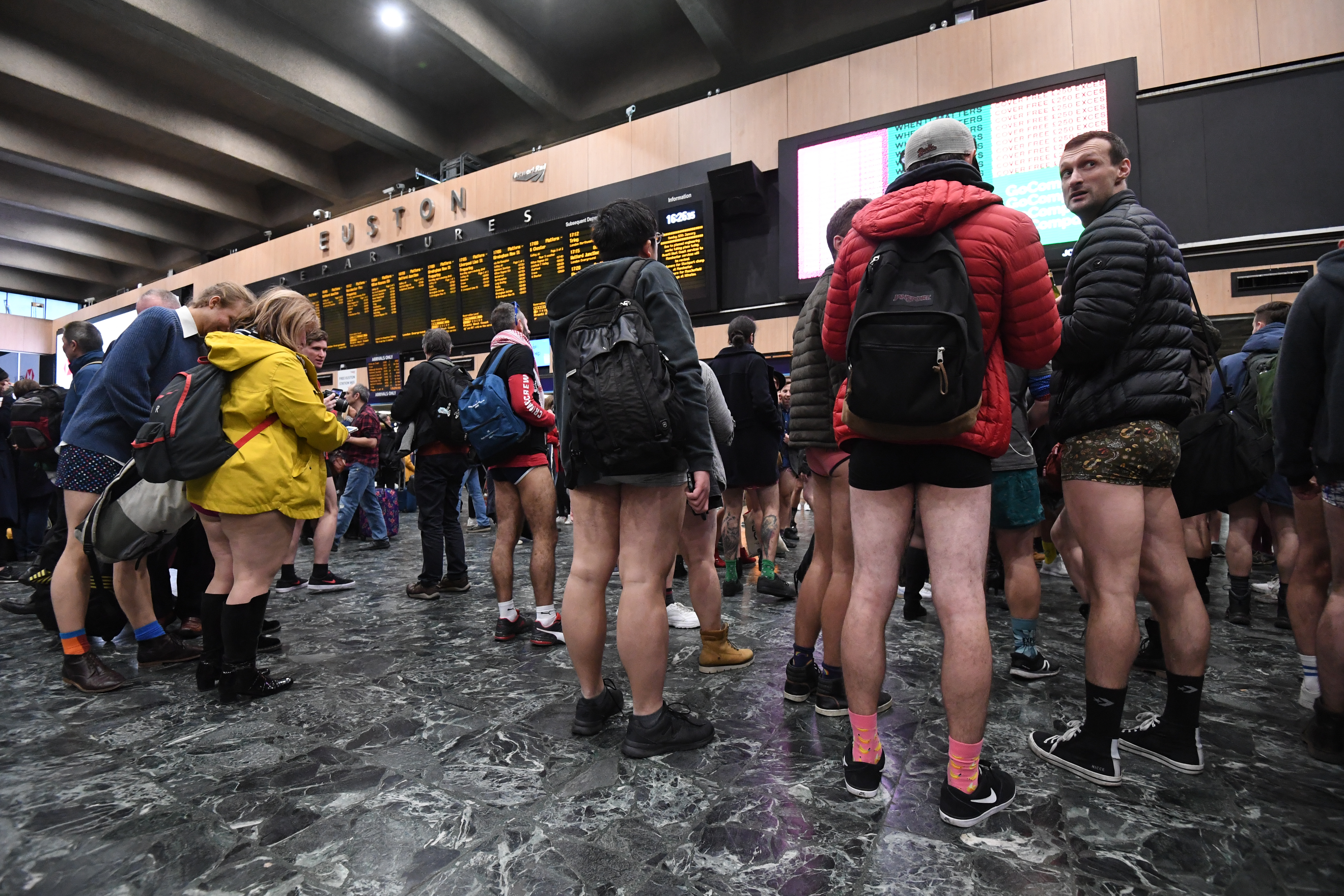 People in the Euston station concourse as they take part in the 11th annual No Trousers Tube Ride in London
