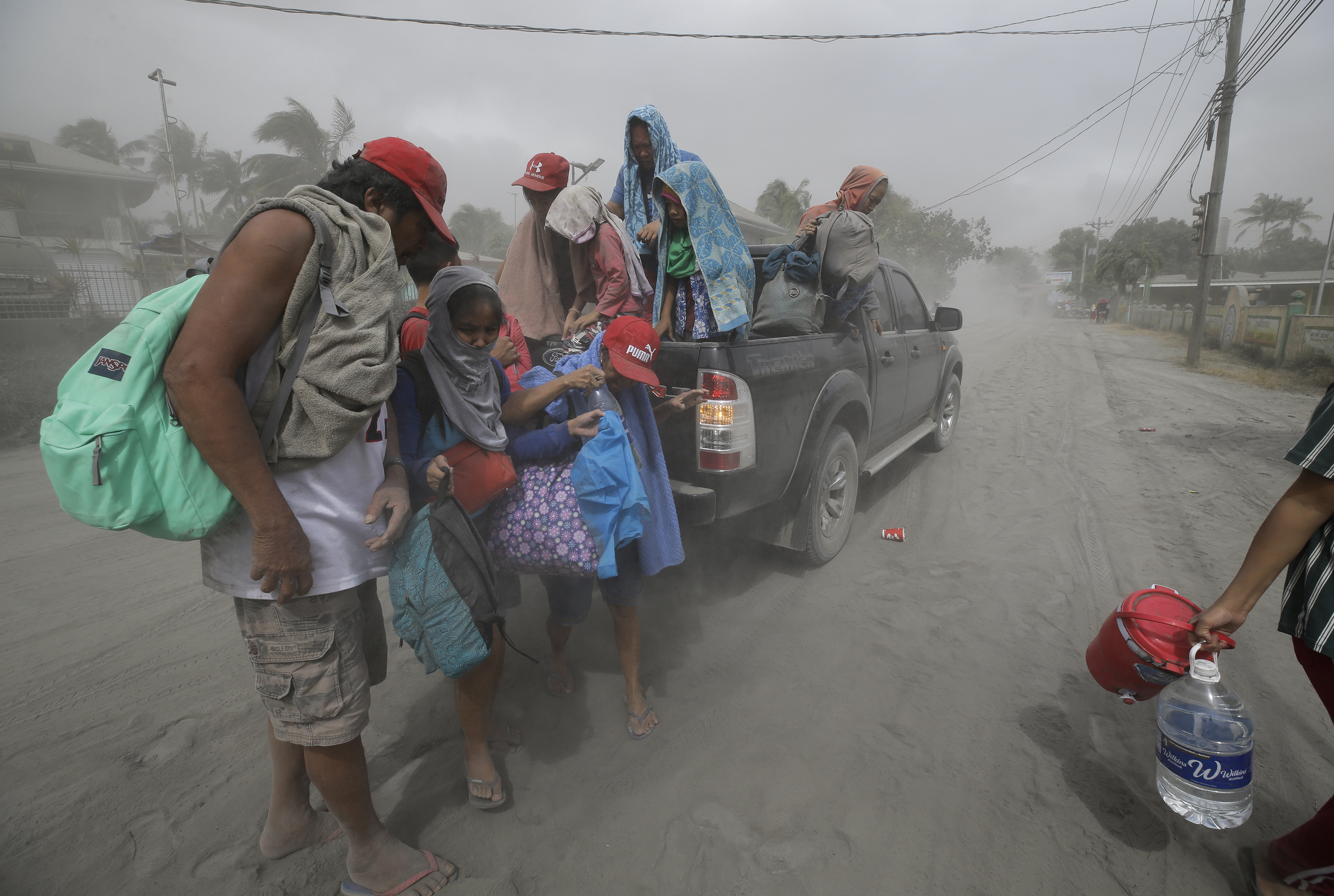 A family evacuates to safer grounds as Taal Volano continues to spew ash in Lemery, Batangas