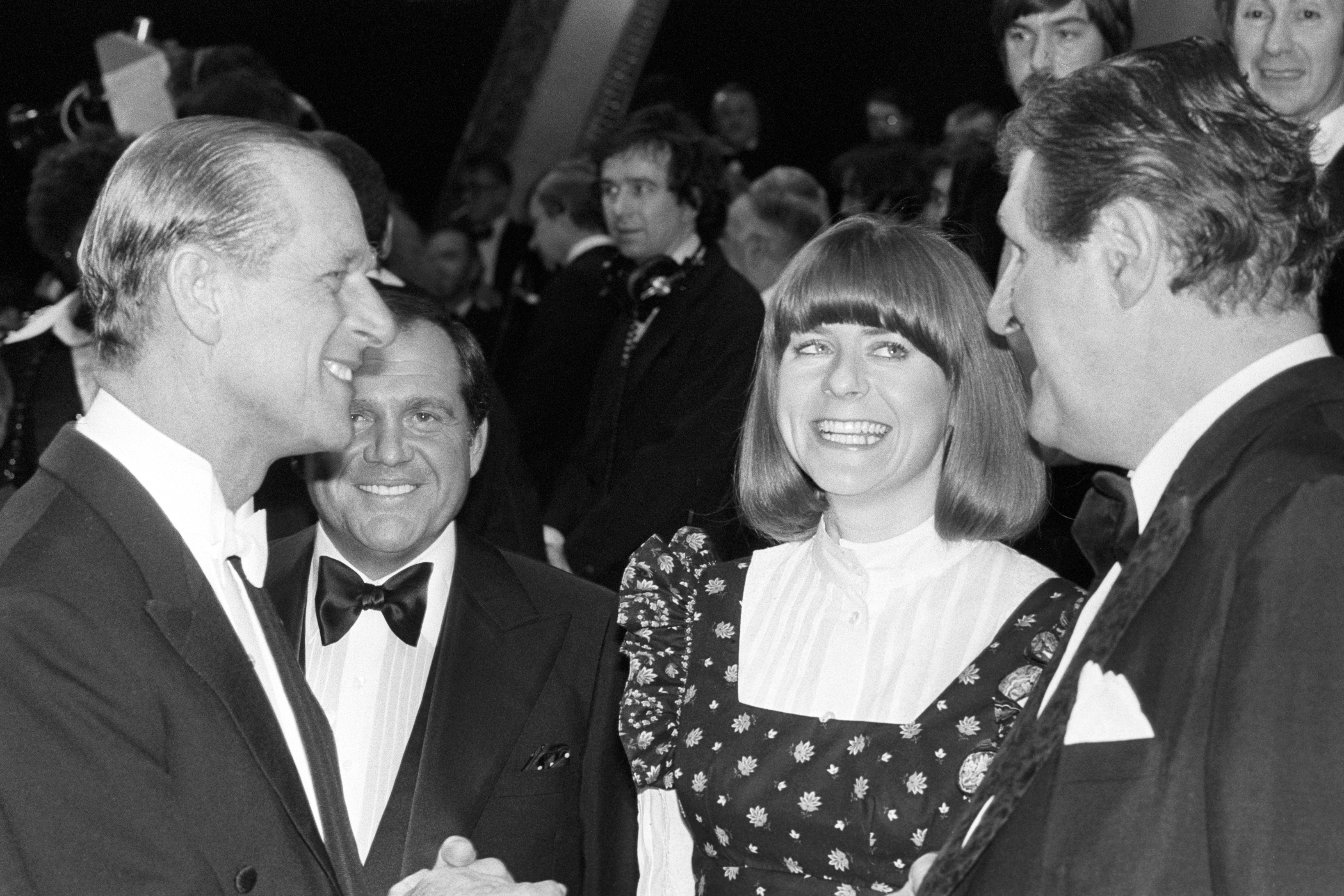 Pam Ayres and comic magician Tommy Cooper talking to the Duke of Edinburgh Silver Jubilee Royal Variety Gala at the London Palladium with Her Majesty the Queen in 1977 (PA)