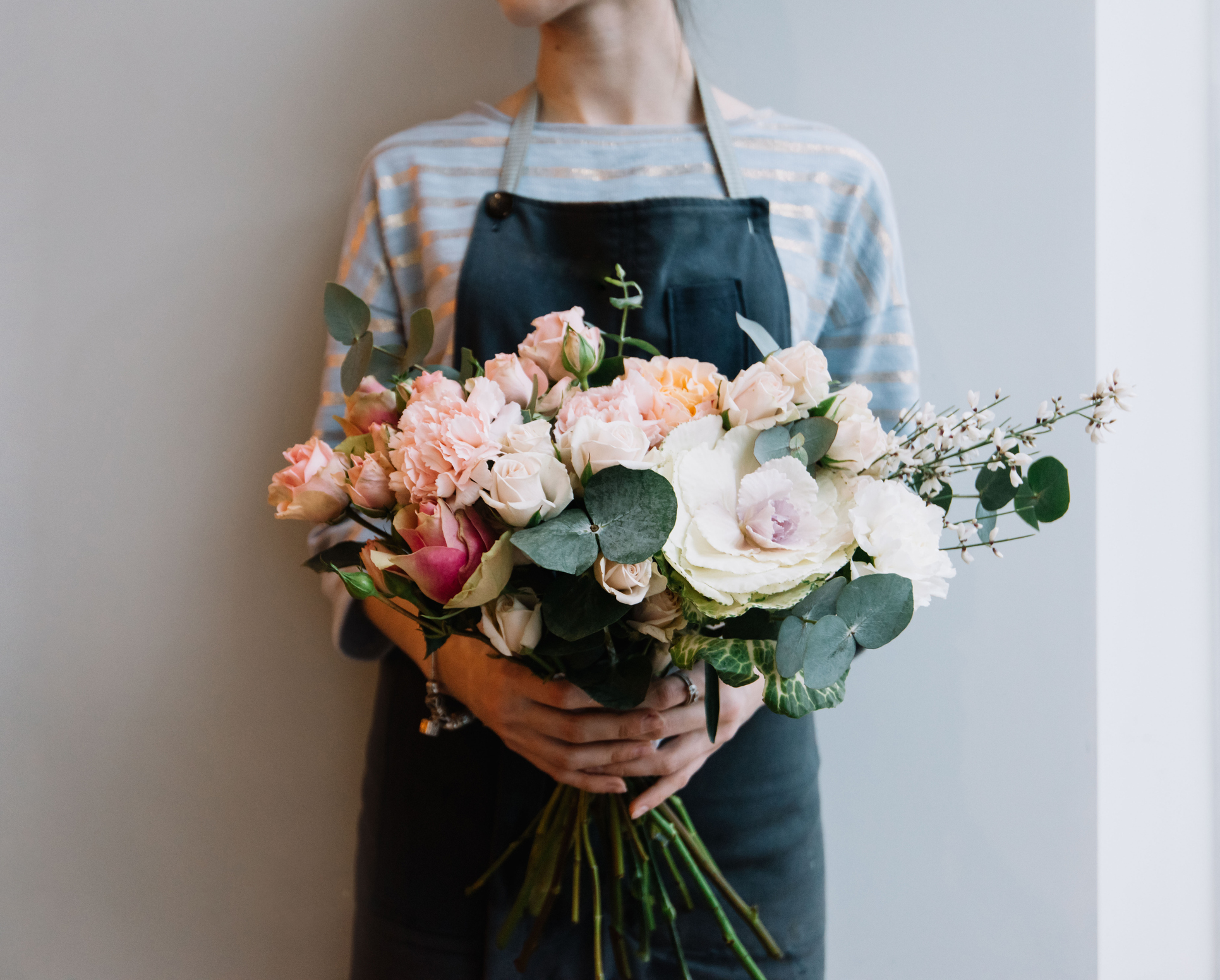 woman holding a bunch of flowers