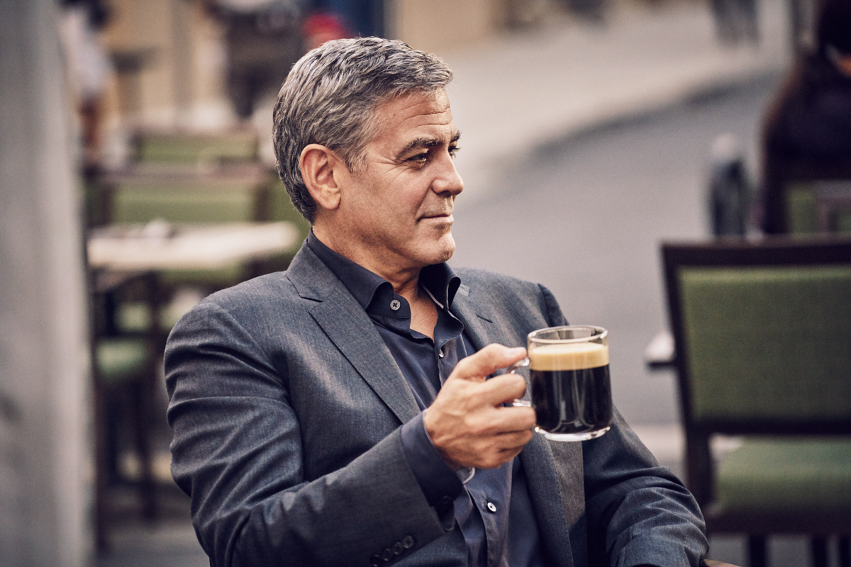 George Clooney drinking a cup of coffee