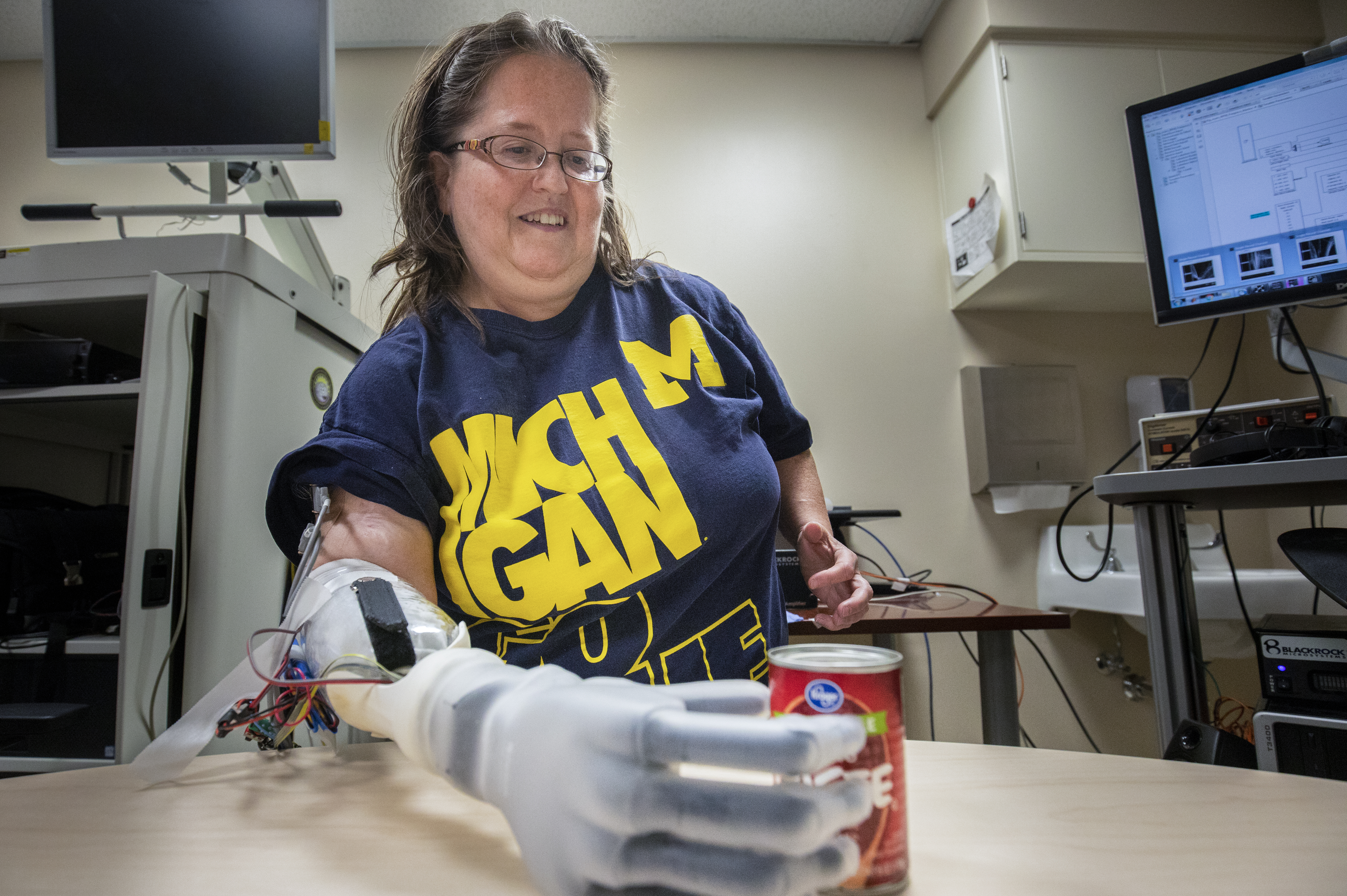 Karen Sussex, a participant in the University of Michigan RPNI study, naturally uses her mind to control her prosthetic hand to pick up a can of tomato paste