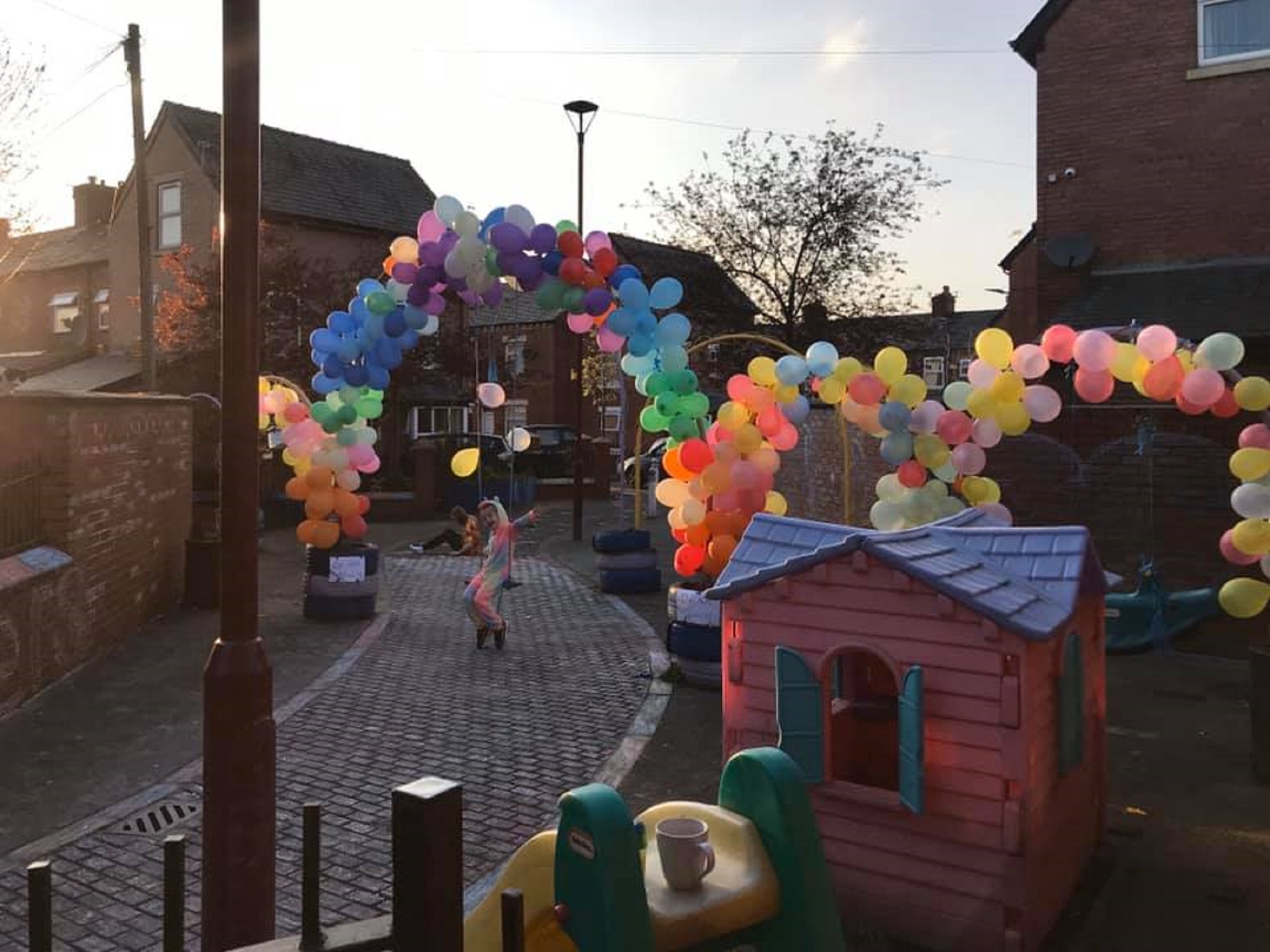 Two sisters have created a giant rainbow tribute to the NHS on their street in Manchester