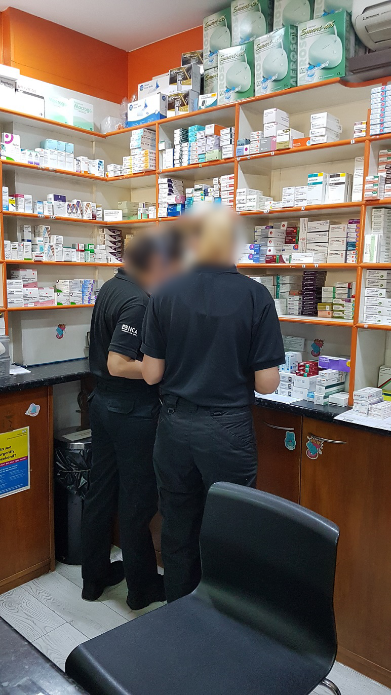 NCA officers search a pharmacy in south London