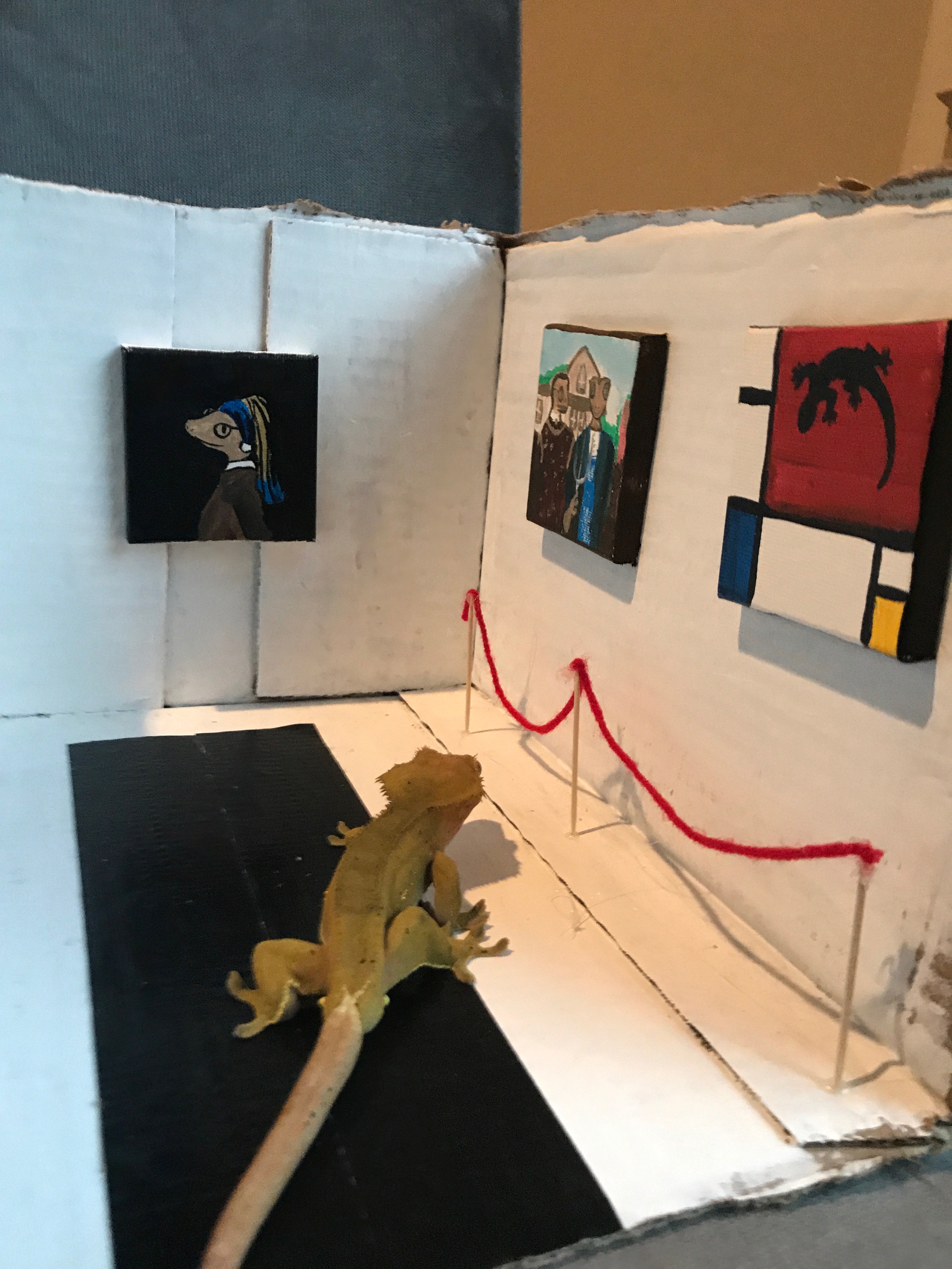 The Mayor, a gecko, in a tiny gecko-themed art gallery