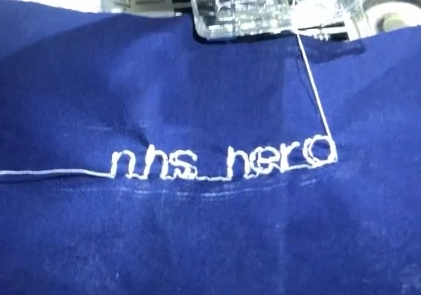 The words 'NHS hero' embroidered into medical scrubs