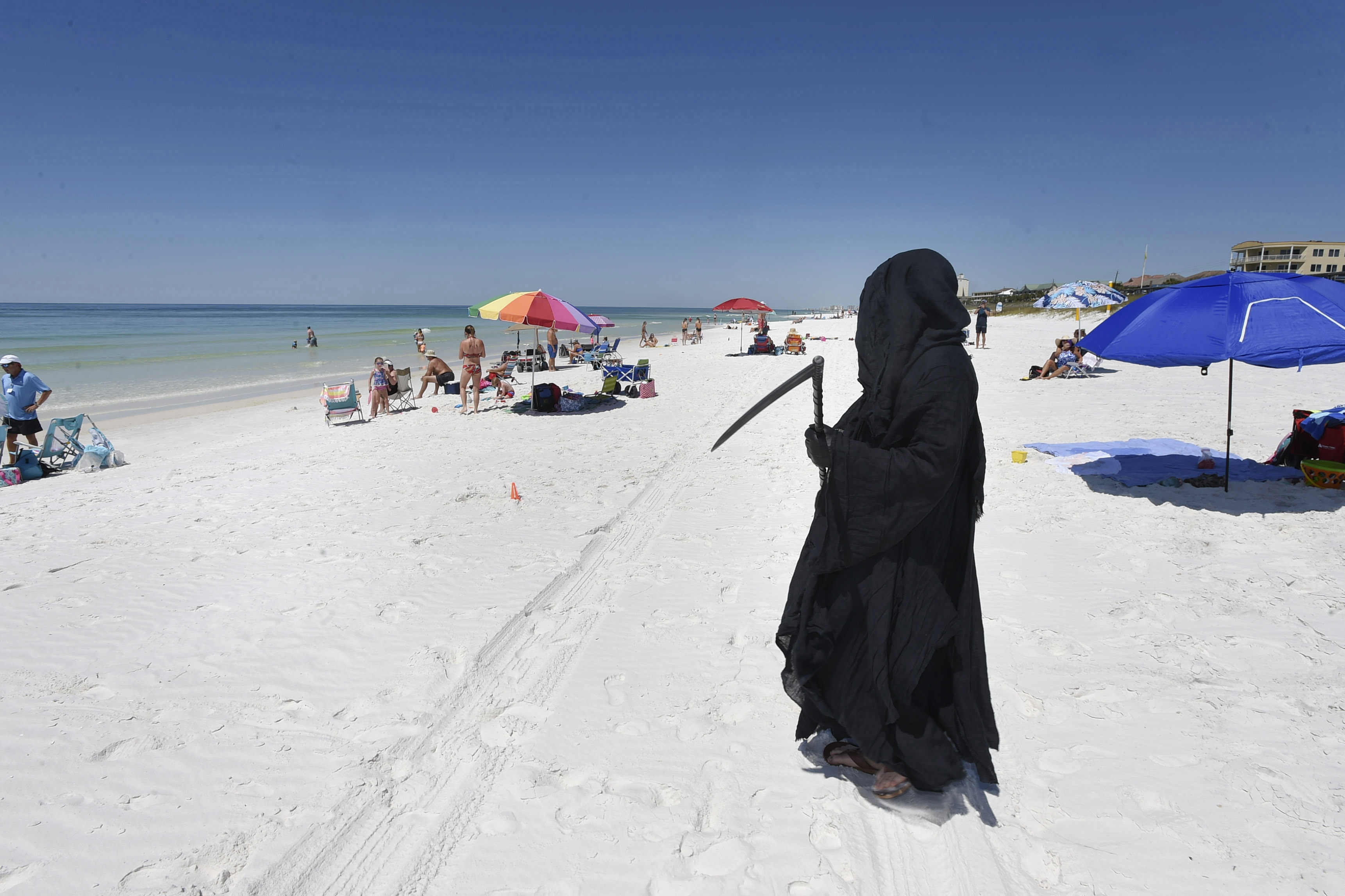 Florida Attorney Daniel Uhlfelder, dressed as the Grim Reaper, walks the newly-opened beach near Destin