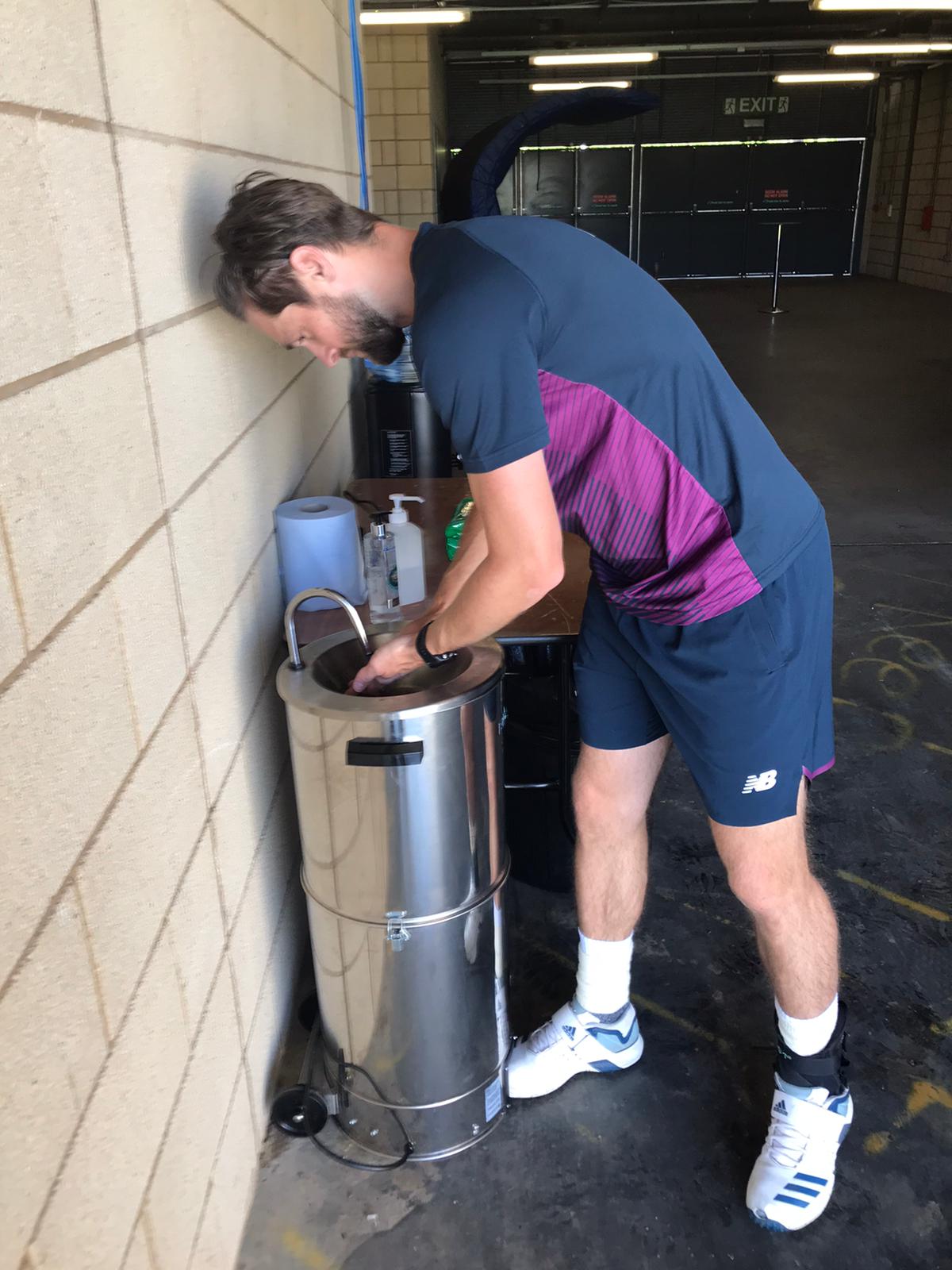 Chris Woakes washes his hands at Edgbaston.