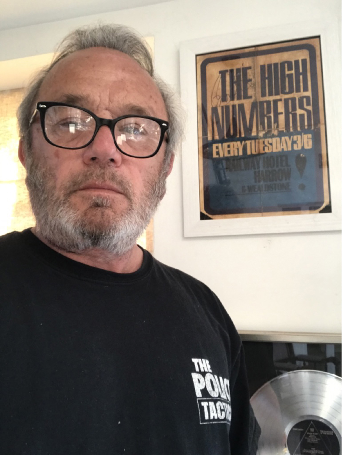 Steve Thrift with a High Numbers poster signed by Roger Daltry (Chippenham Auction Rooms/PA)