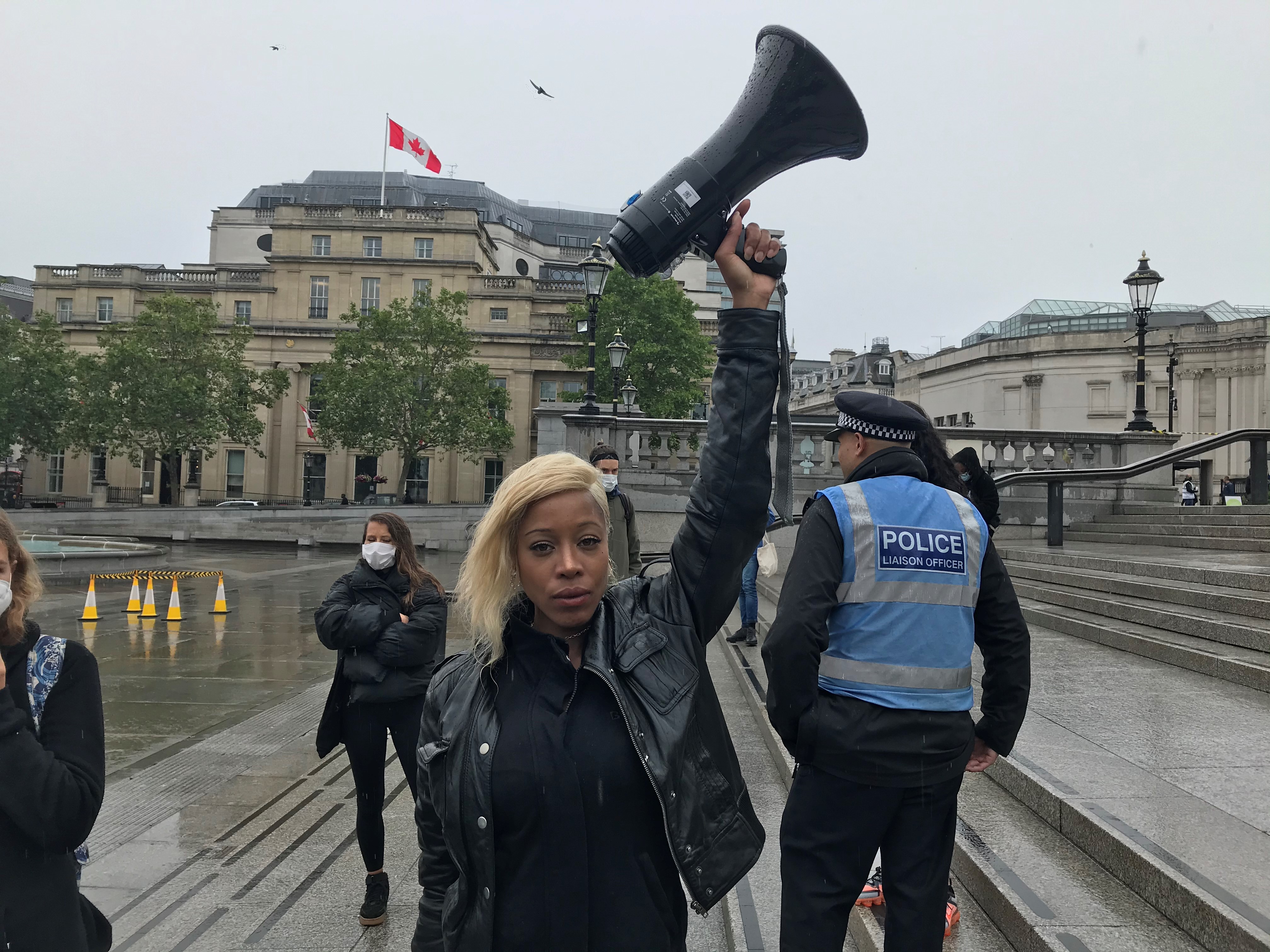 Justice for Black Lives protester Imarn Ayton, 29, urging supporters to protest peacefully in Trafalgar Square, central London on Wednesday.