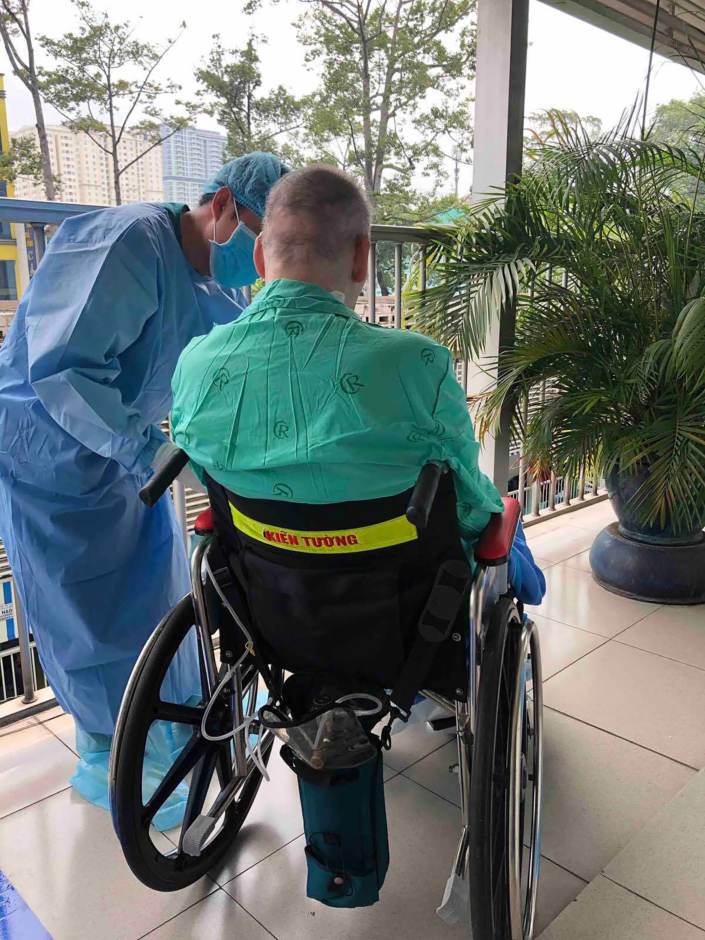 A doctor attends to 'Patient 91', a British pilot who survived Covid-19, at Cho Ray Hospital 