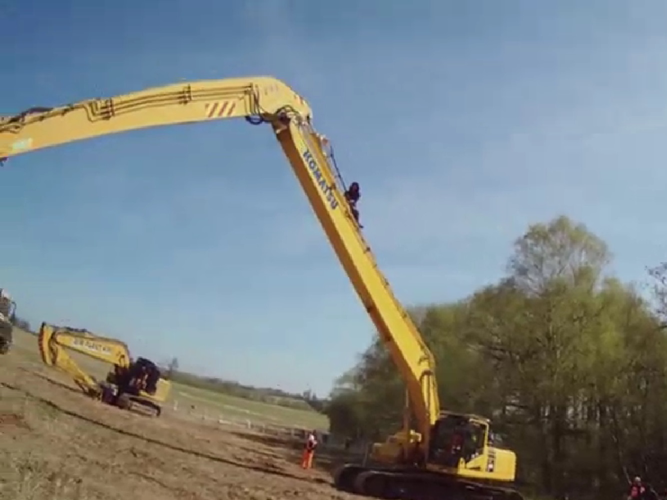 Protester on tree-cutter machine