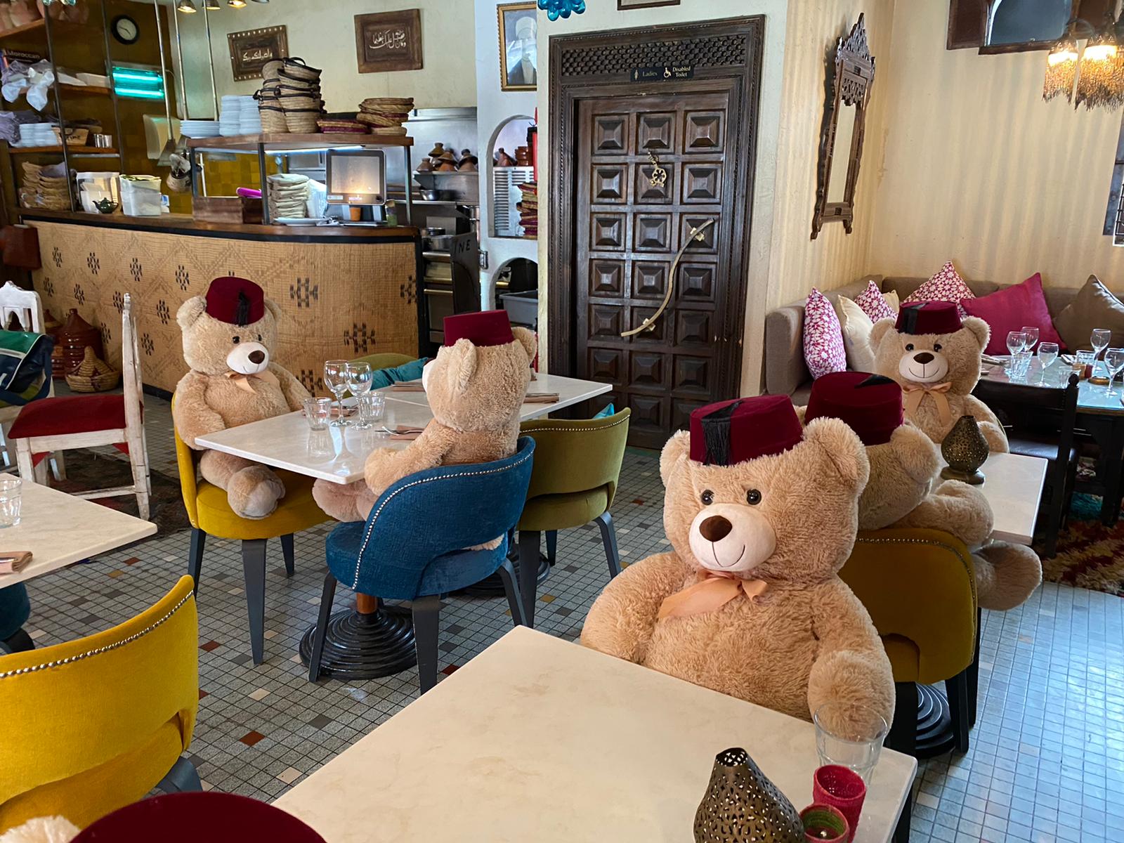 Cuddly toy bears sit in seats at Tagine in Balham to enforce social distancing at the restaurant