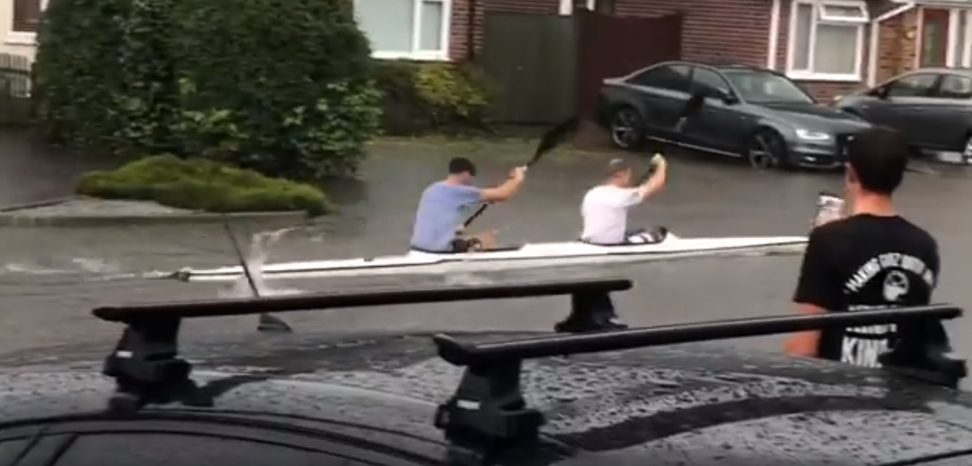 Two people in a kayak on a street in Chelmsford