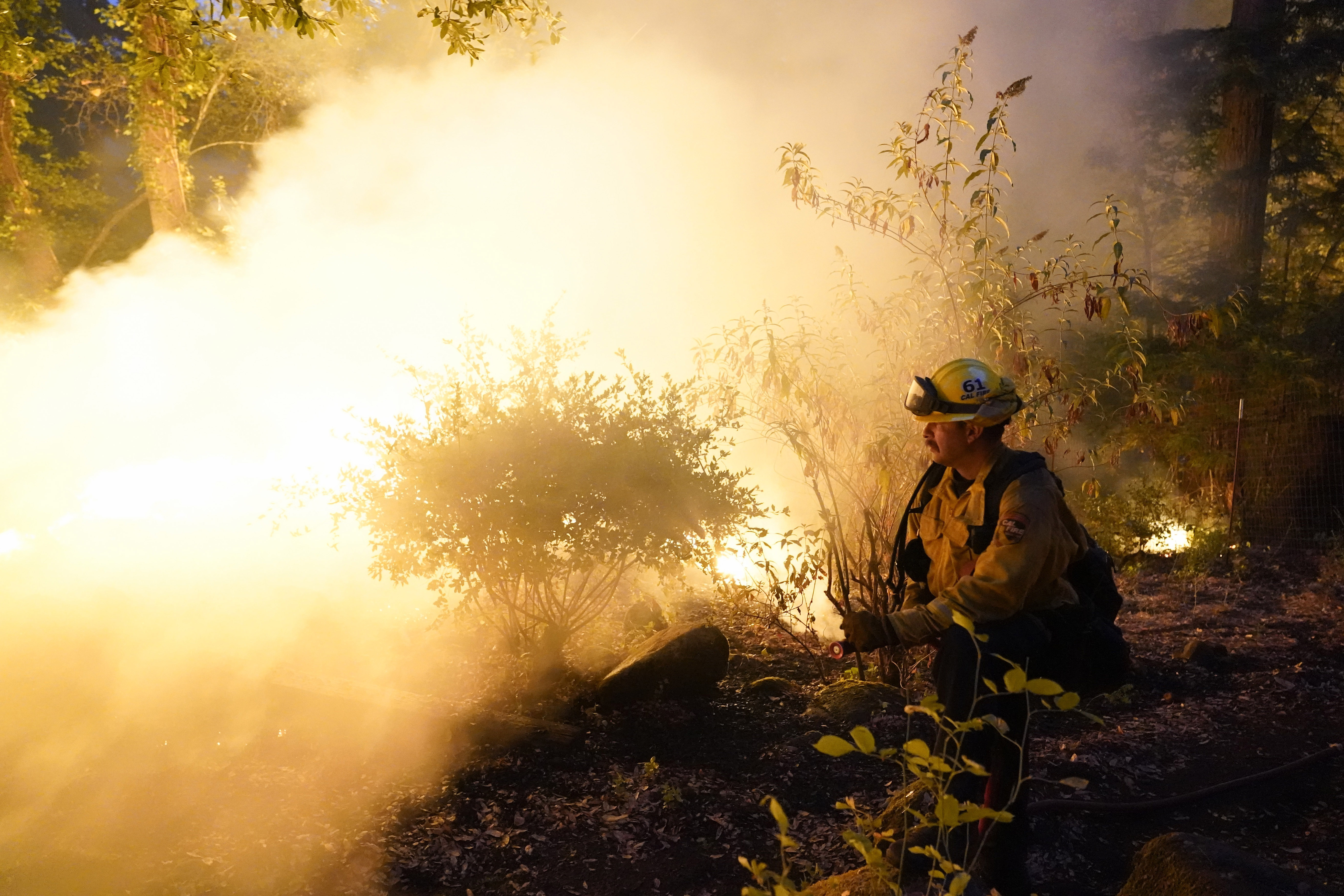 A firefighter monitors a controlled burn