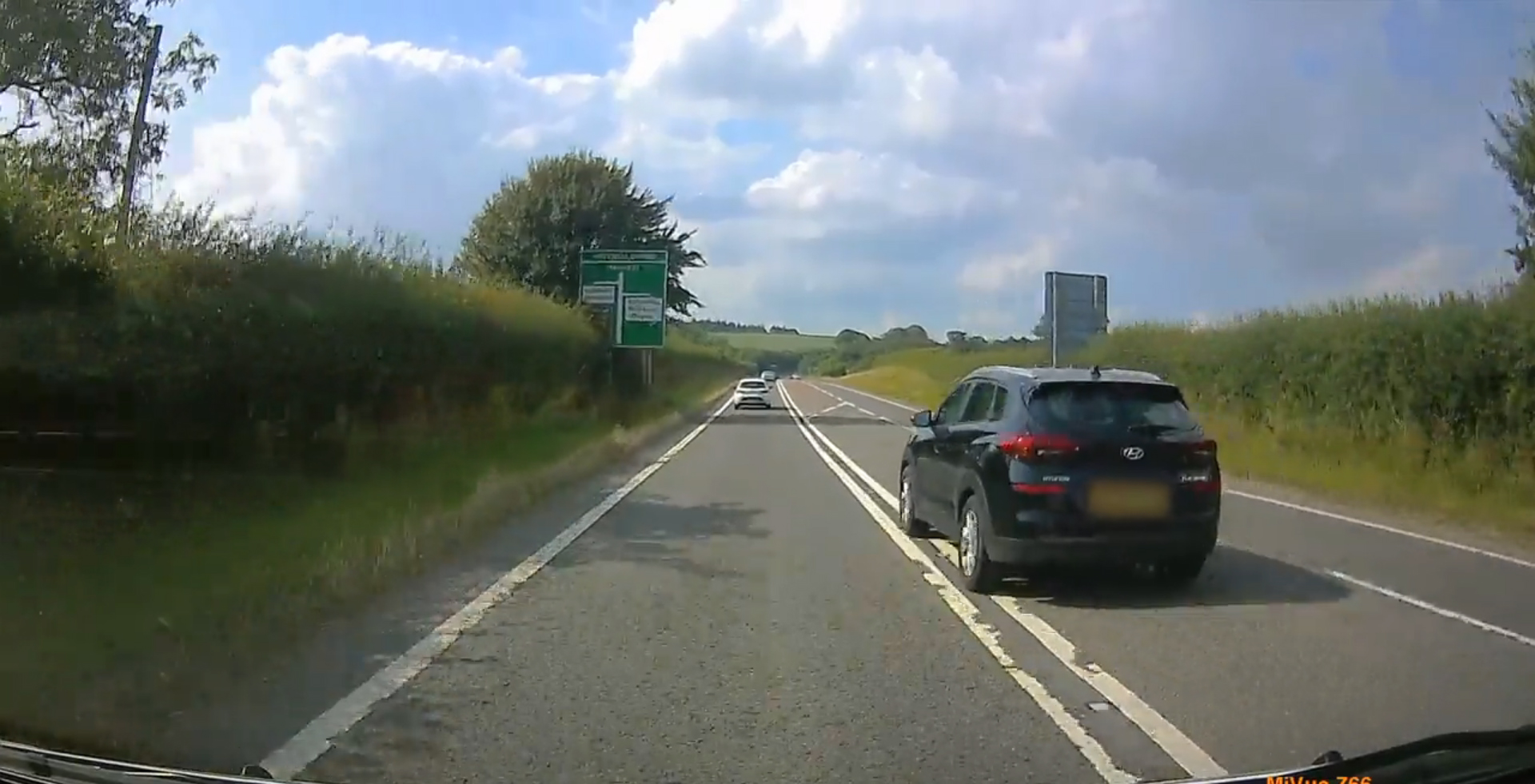 This motorist was caught on dashcam overtaking another car by crossing double white lines (Dorset Police/PA).