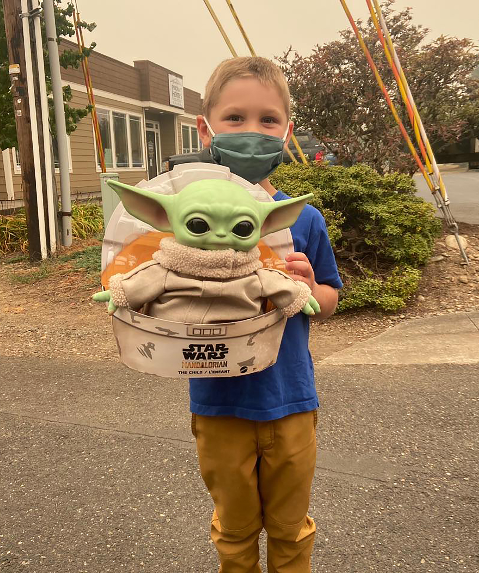 Five-year-old Carver holds up a Baby Yoda toy in Scappoose, Oregon