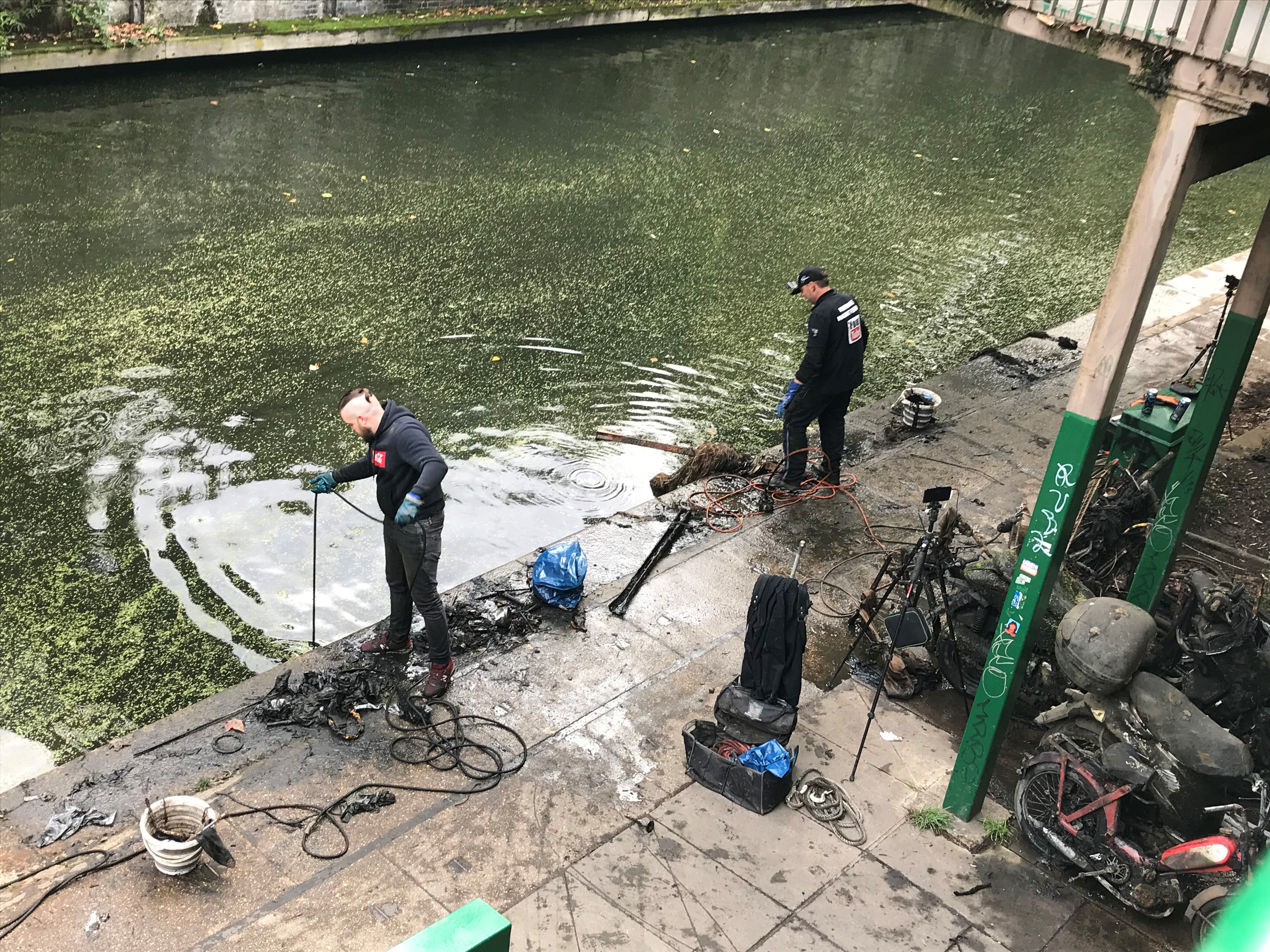 Magnet fishers Nigel Lamford and Jim Norton trawl Regent's Canal for metal objects on Sunday October 11, 2020 (Laura Parnaby/PA). 