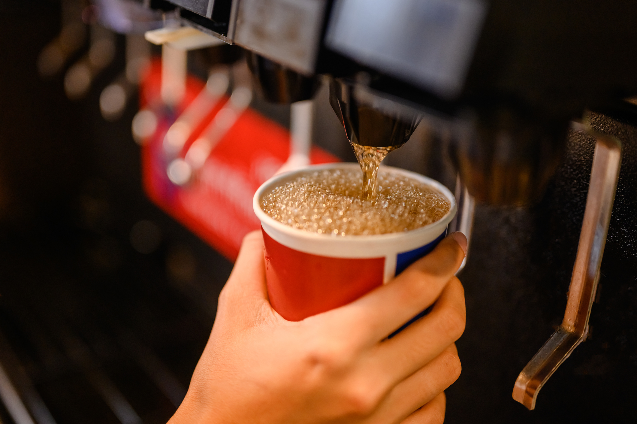 Man pouring out fizzy drink