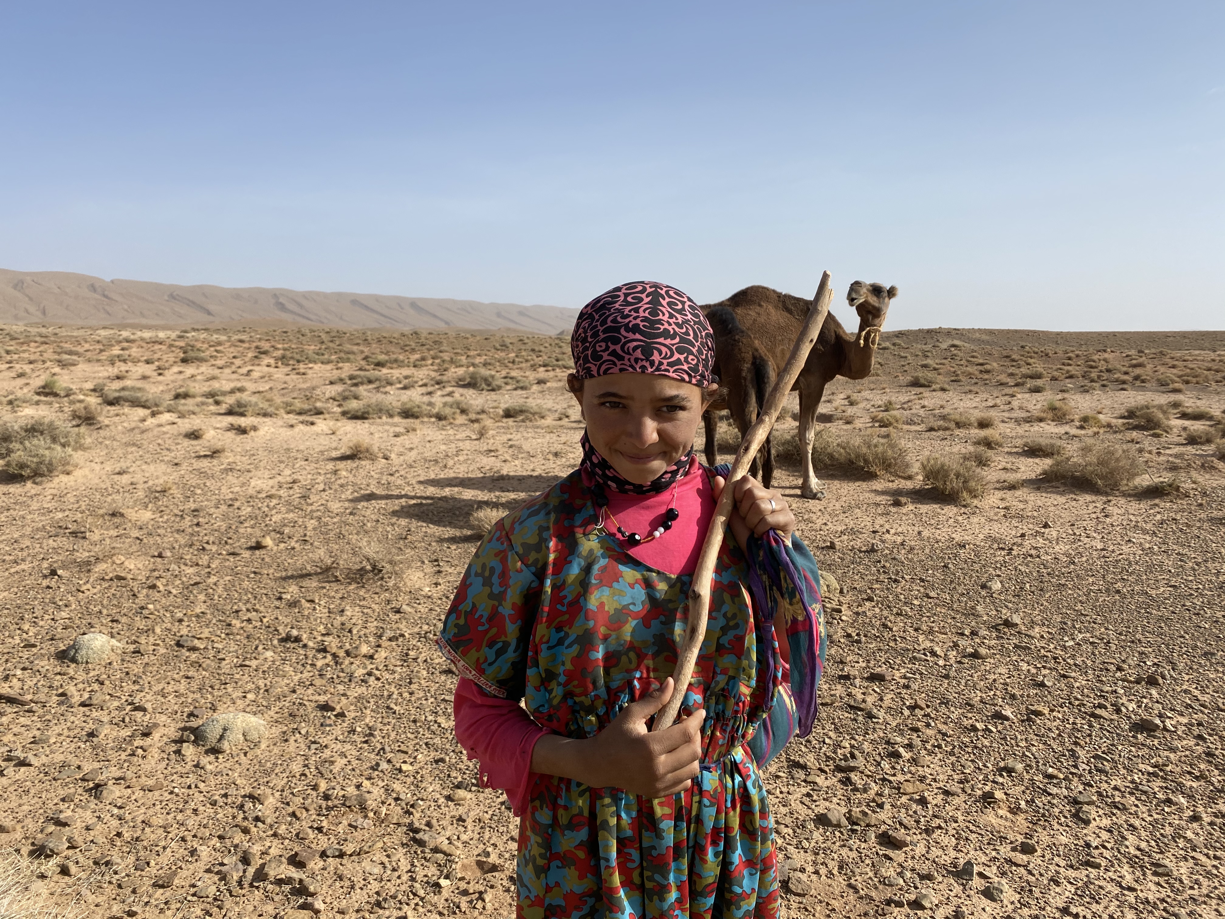 Nomad girl herding her camels.
