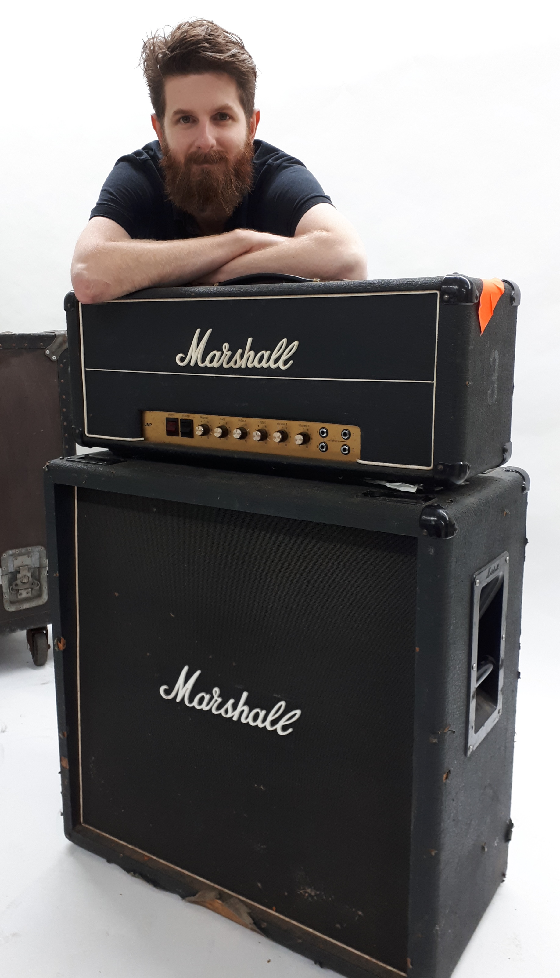 Auctioneer Luke Hobbs with one of Bernie Marsden's amps and speakers (Gardiner Houlgate/PA)