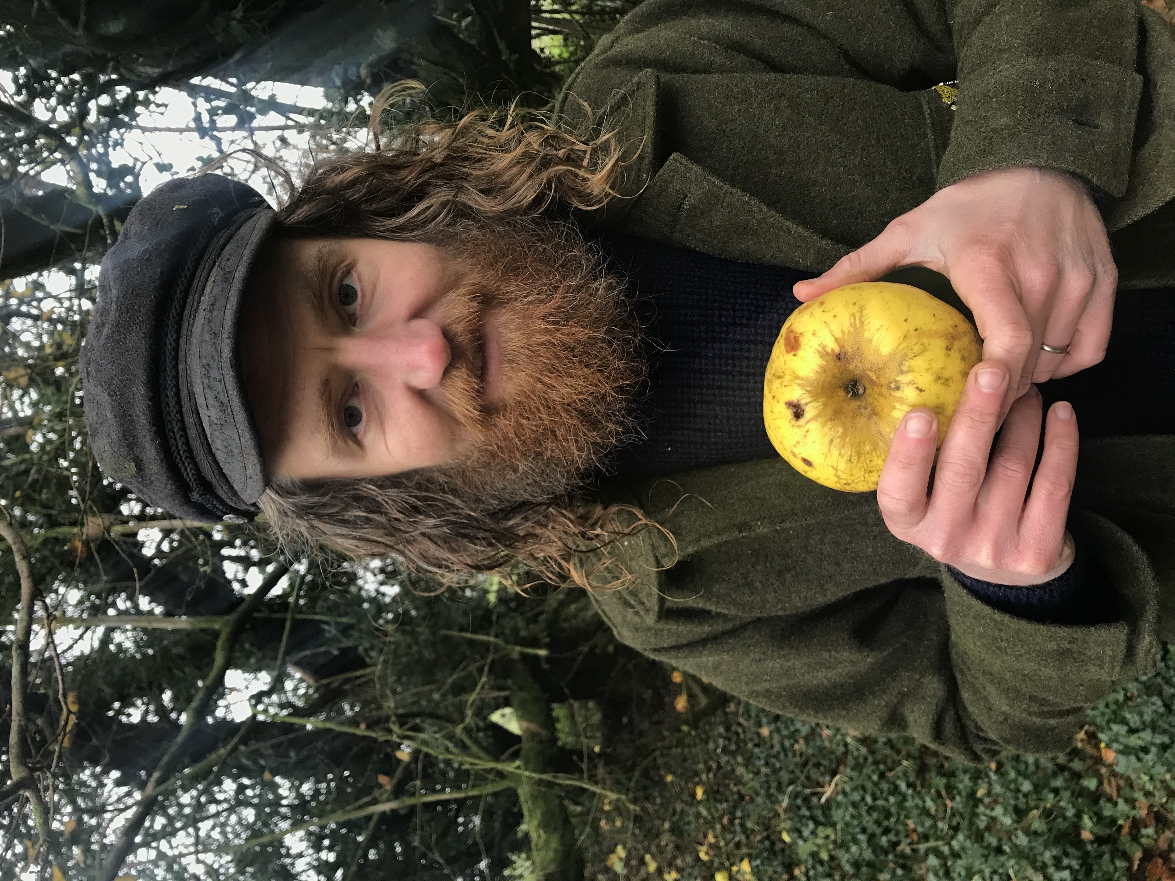 Archie Thomas holding his apple find in woodlands near his home (Hannah Thomas/PA)