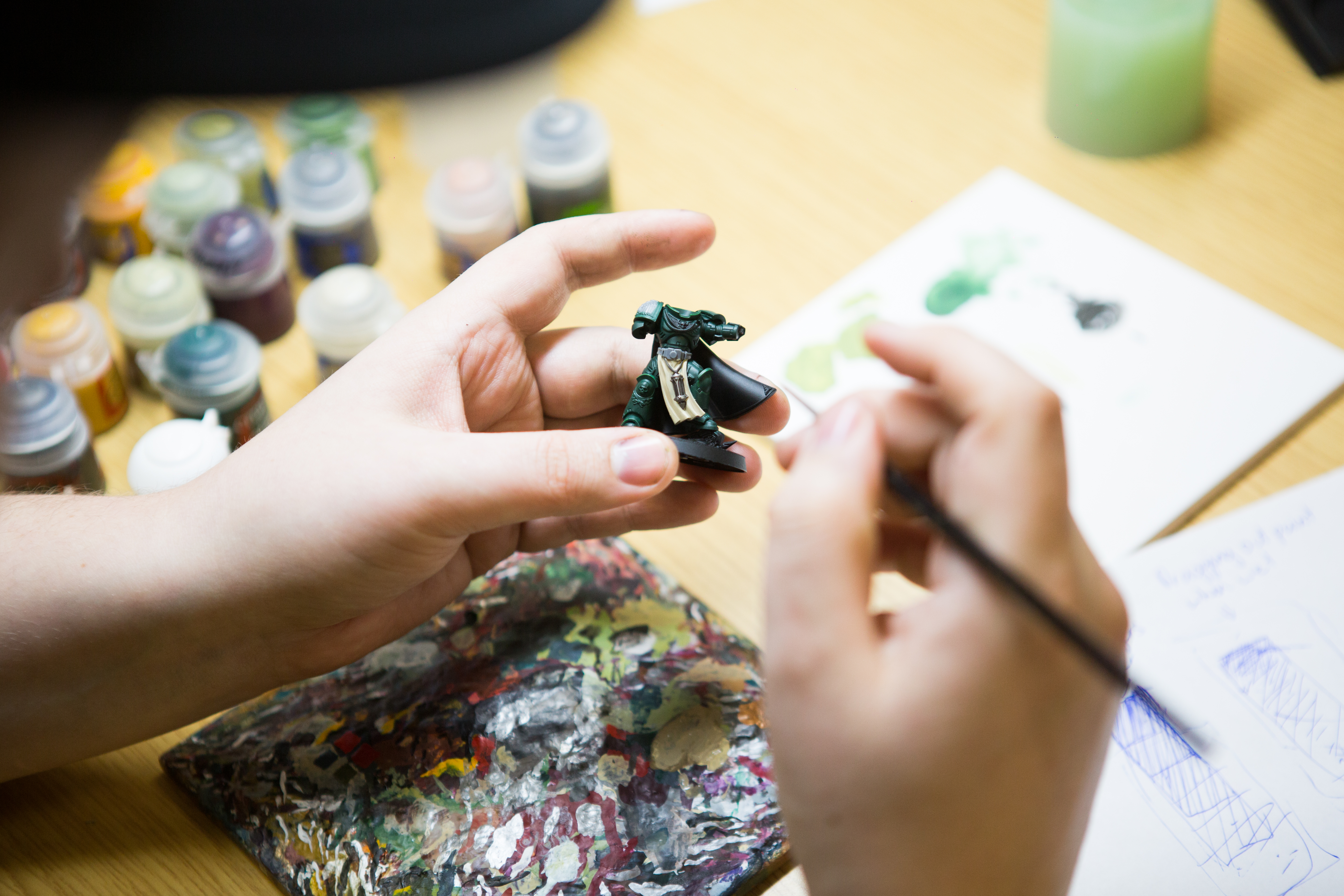 Someone painting a figurine