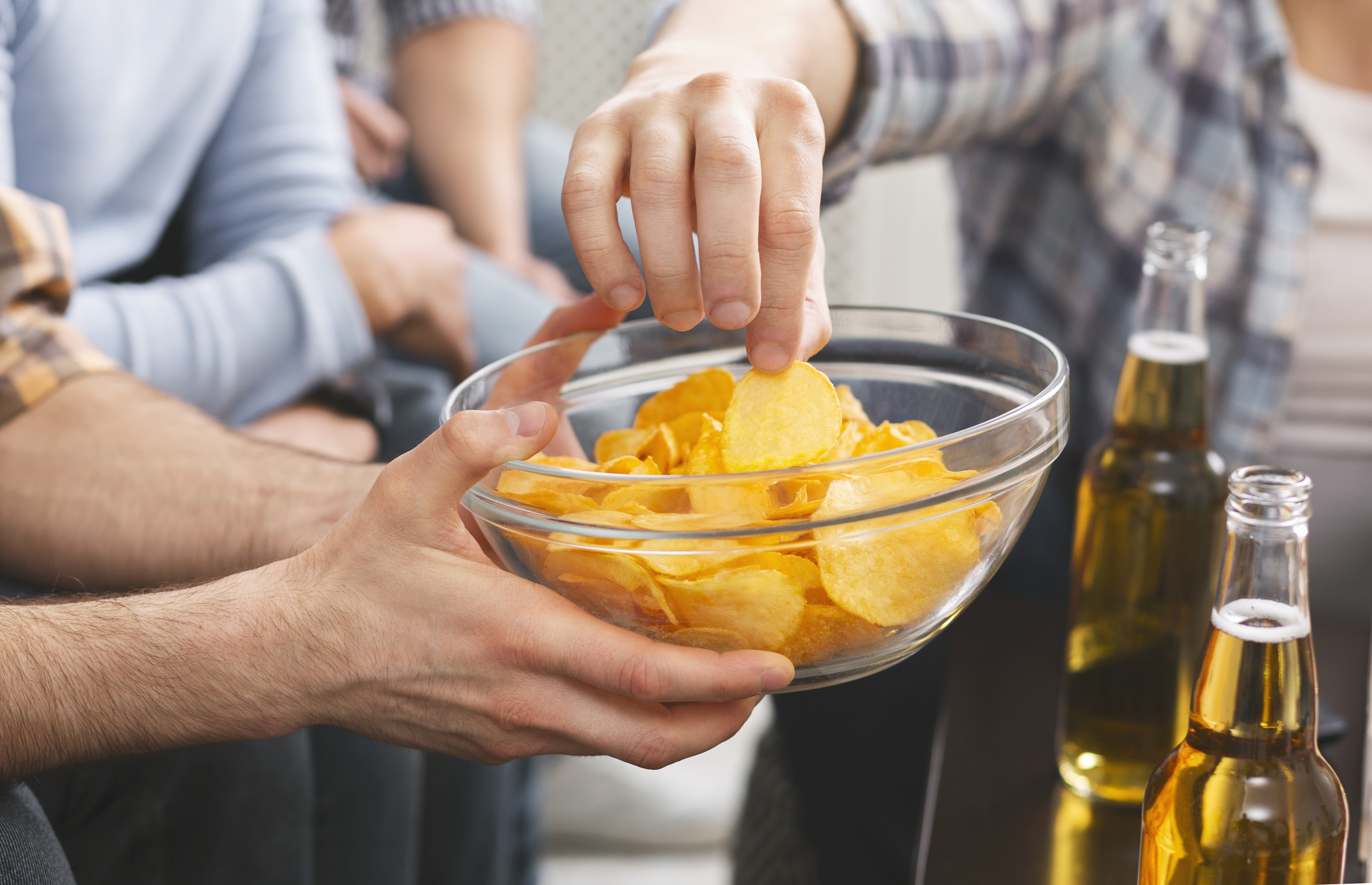 people sharing a bowl of crisps