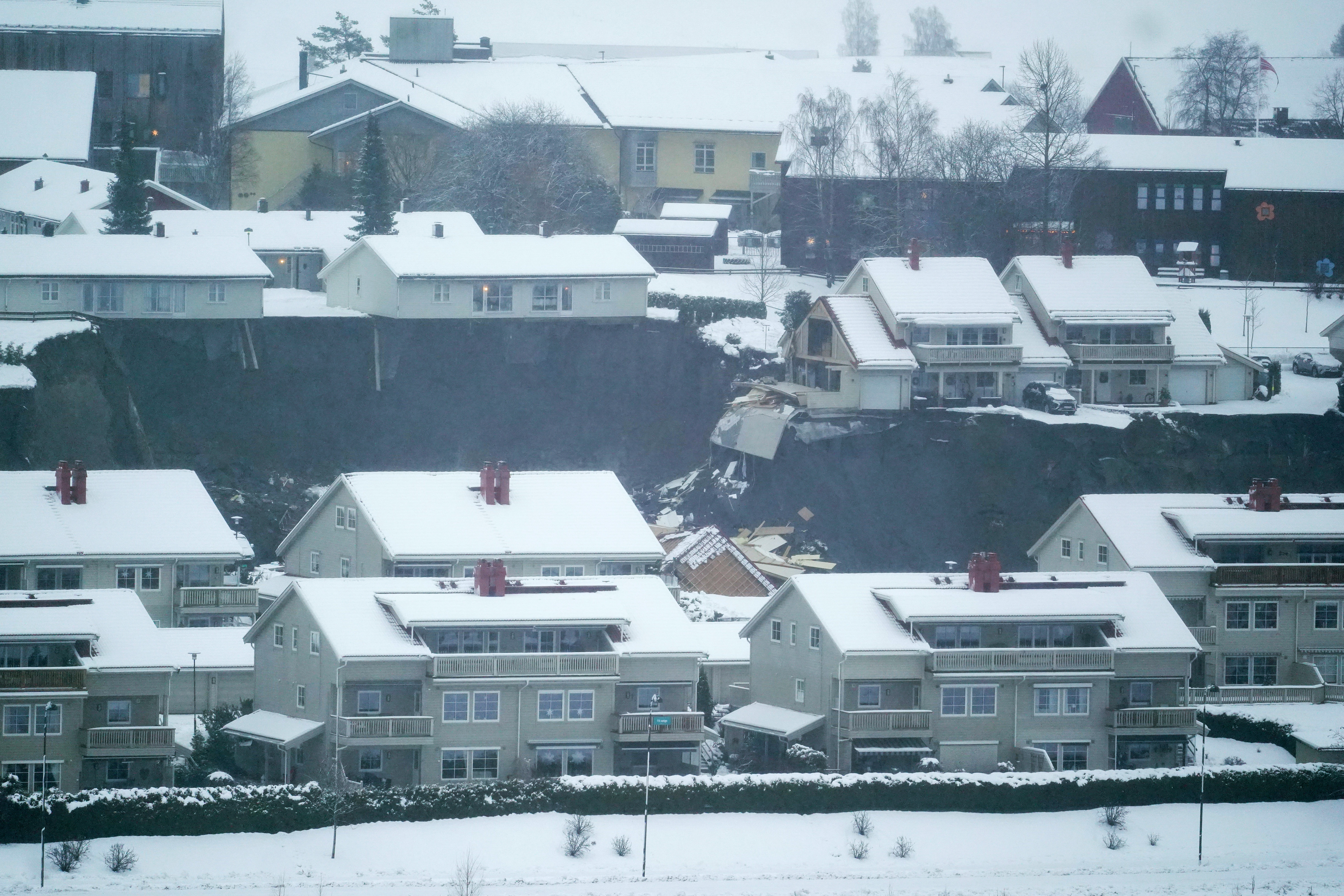 Some houses remain standing while others are seen damaged after a landslide occurred in a residential area in Ask, near Oslo