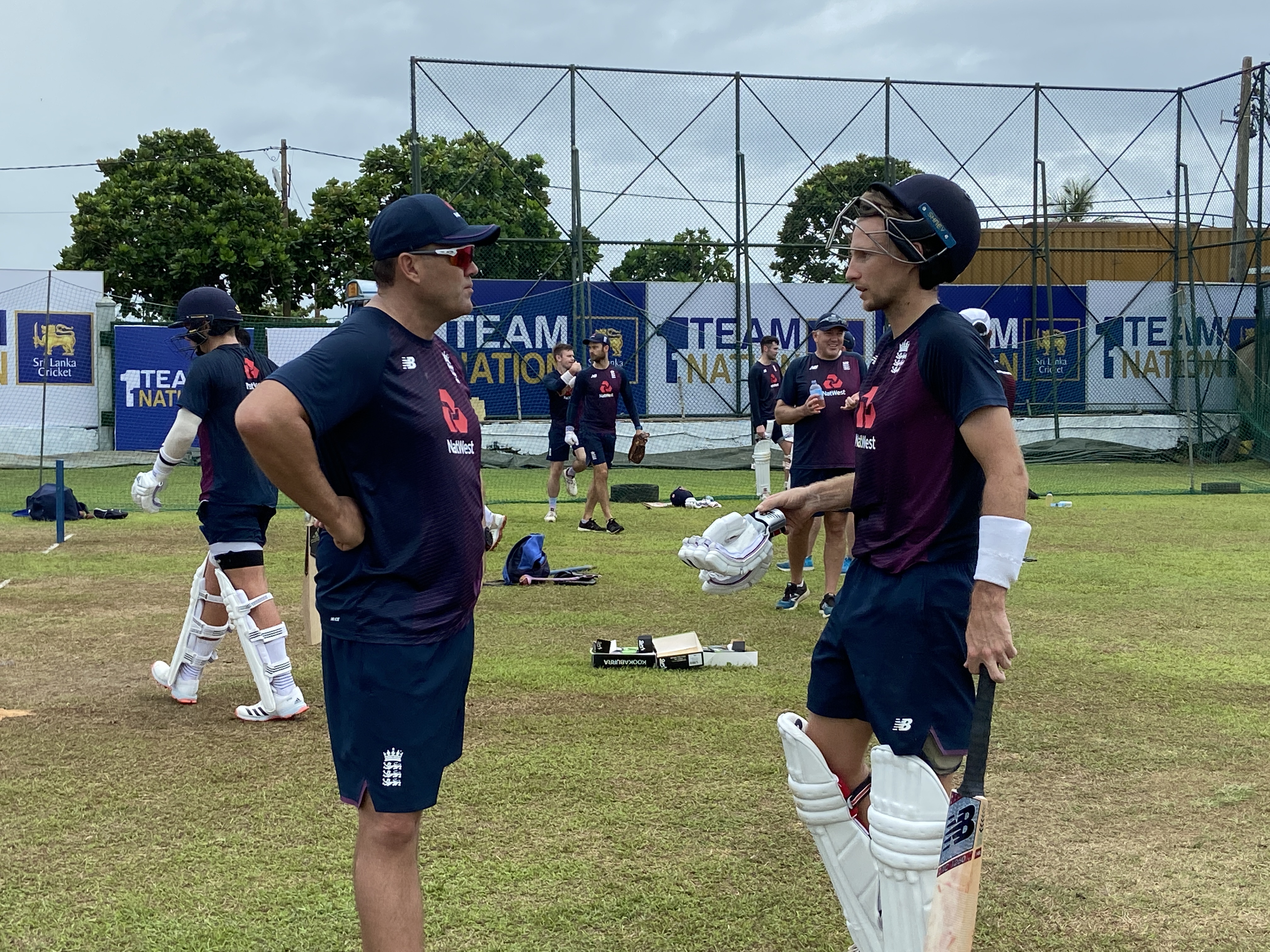 Jacques Kallis (left) shares some tips with England captain Joe Root (right)