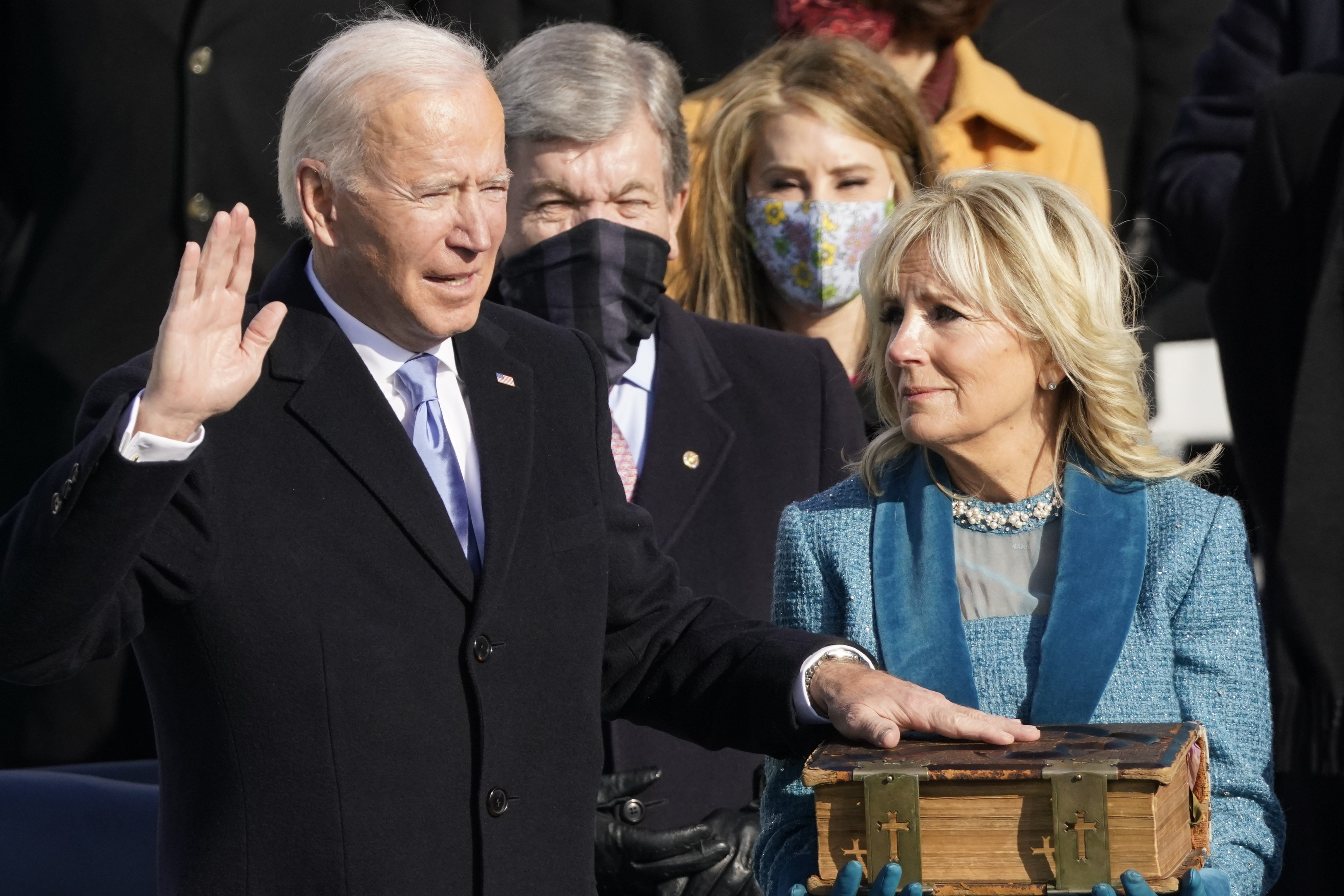 Joe Biden is sworn in as the 46th president of the United States by Chief Justice John Roberts as Jill Biden holds the Bible at the US Capitol in Washington